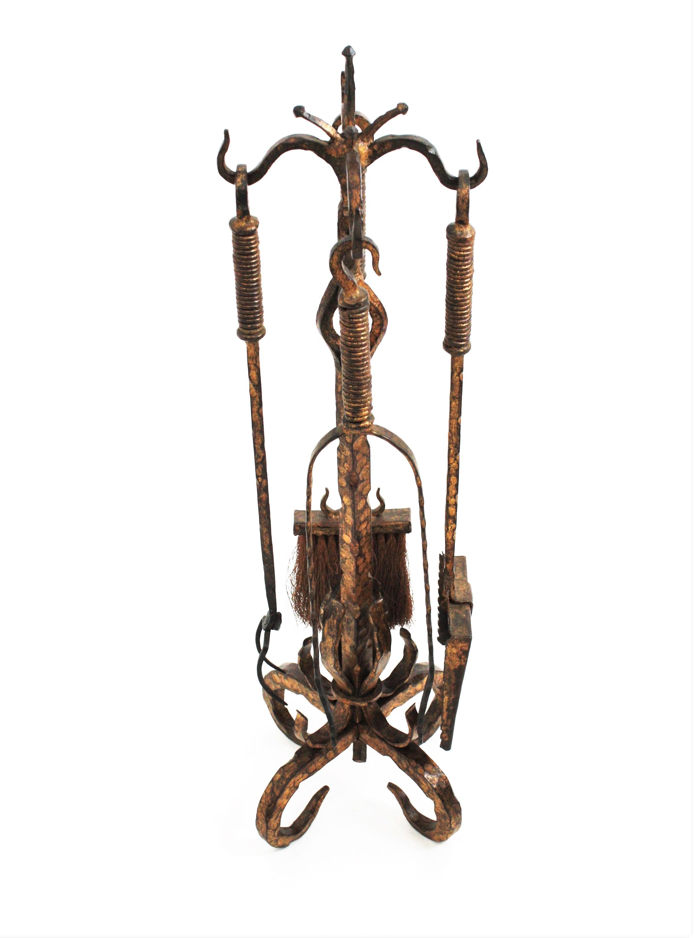 Beautiful Gothic style hand forged antique fireplace tool set on stand. Spain, 1850s
The set includes a stand with four tools: a shovel, a log poker, broom, and tongs. The rack stands up on a four-footed base with scroll-ending feet.
All the tools