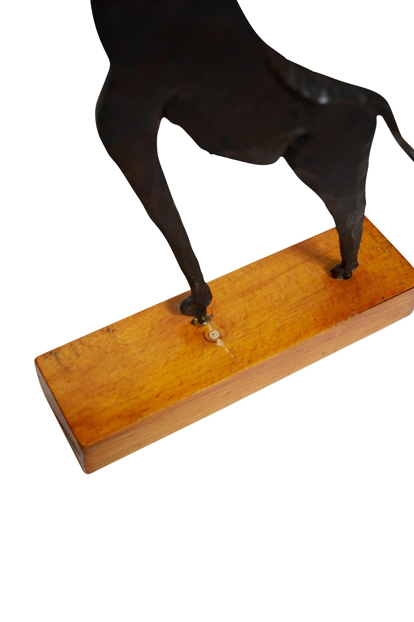 Mid-century wrought iron sculpture with wood base. Very cool. Circa 1970.

Dimensions: 16
