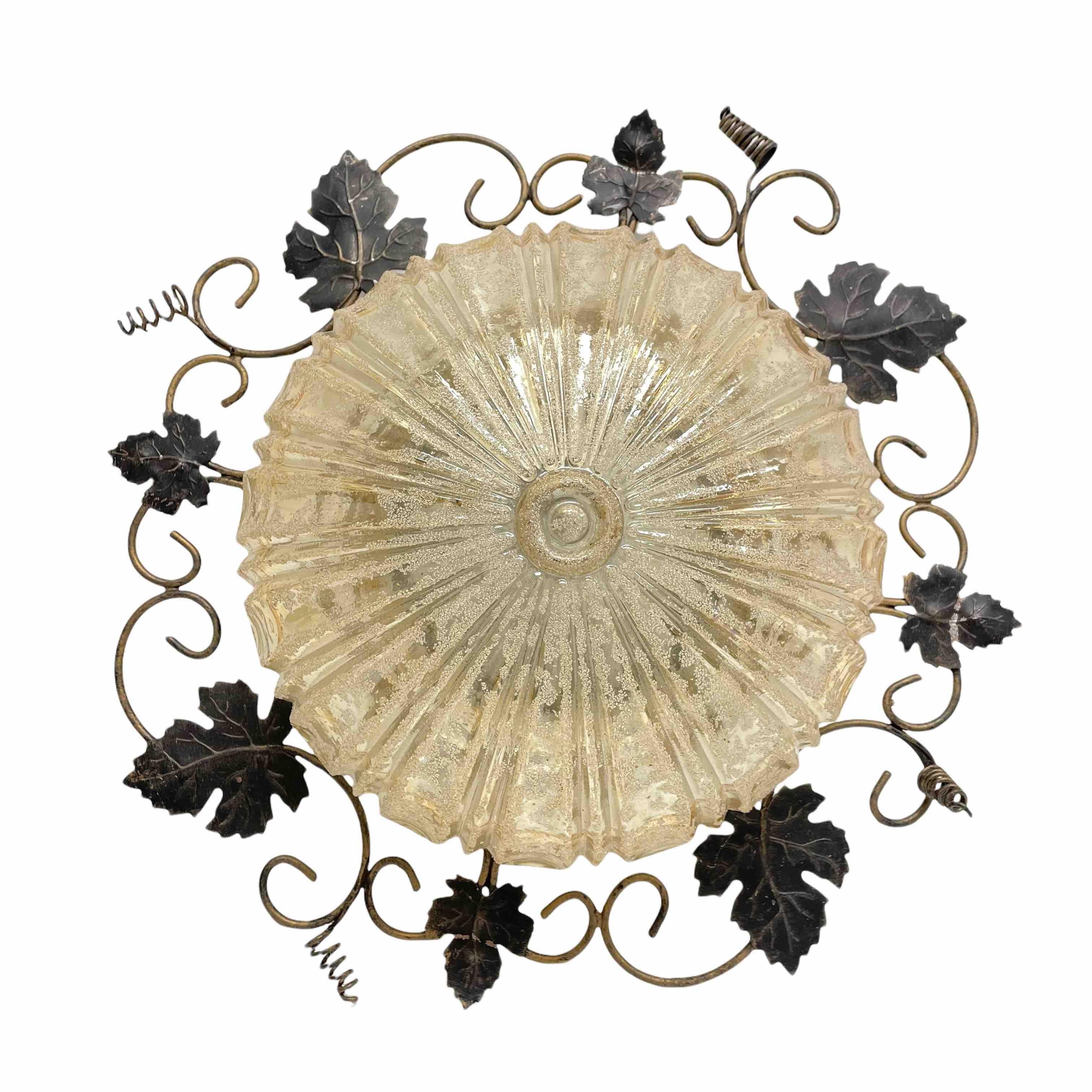 A beautiful flush mount made of wrought iron with an amber colored glass. Gorgeous textured amber colored glass flush mount with metal fixture. The fixture requires one European E27 Edison or medium bulb up to 60 watts. A nice addition to any room