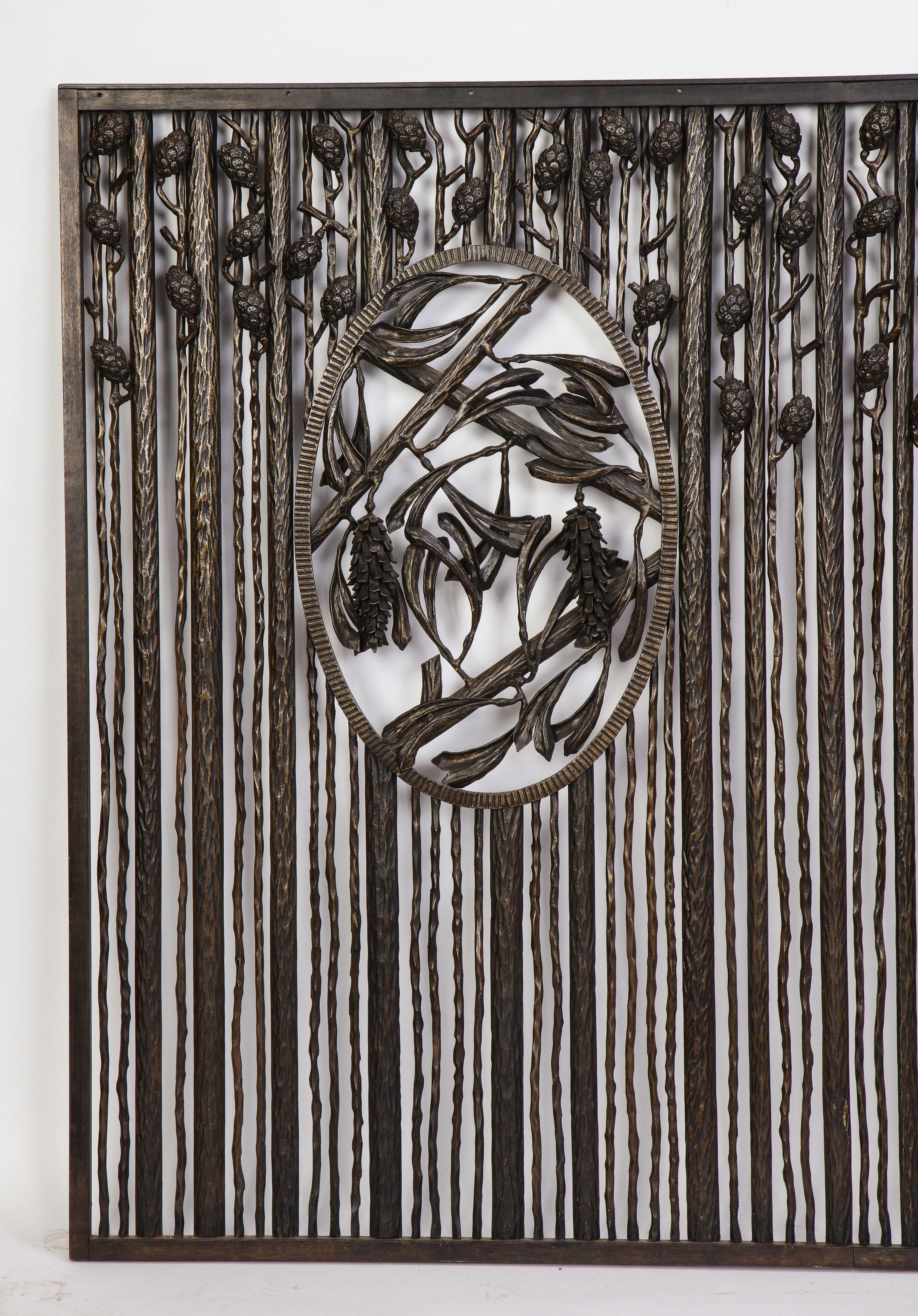 A modern, art deco, wrought-iron grate in the style of Edgar Brandt. Modeled as branches suspending pine cones, this piece pairs well with Black Forest design. When paired with bright flowers, the piece causes a juxtaposition and conversation
