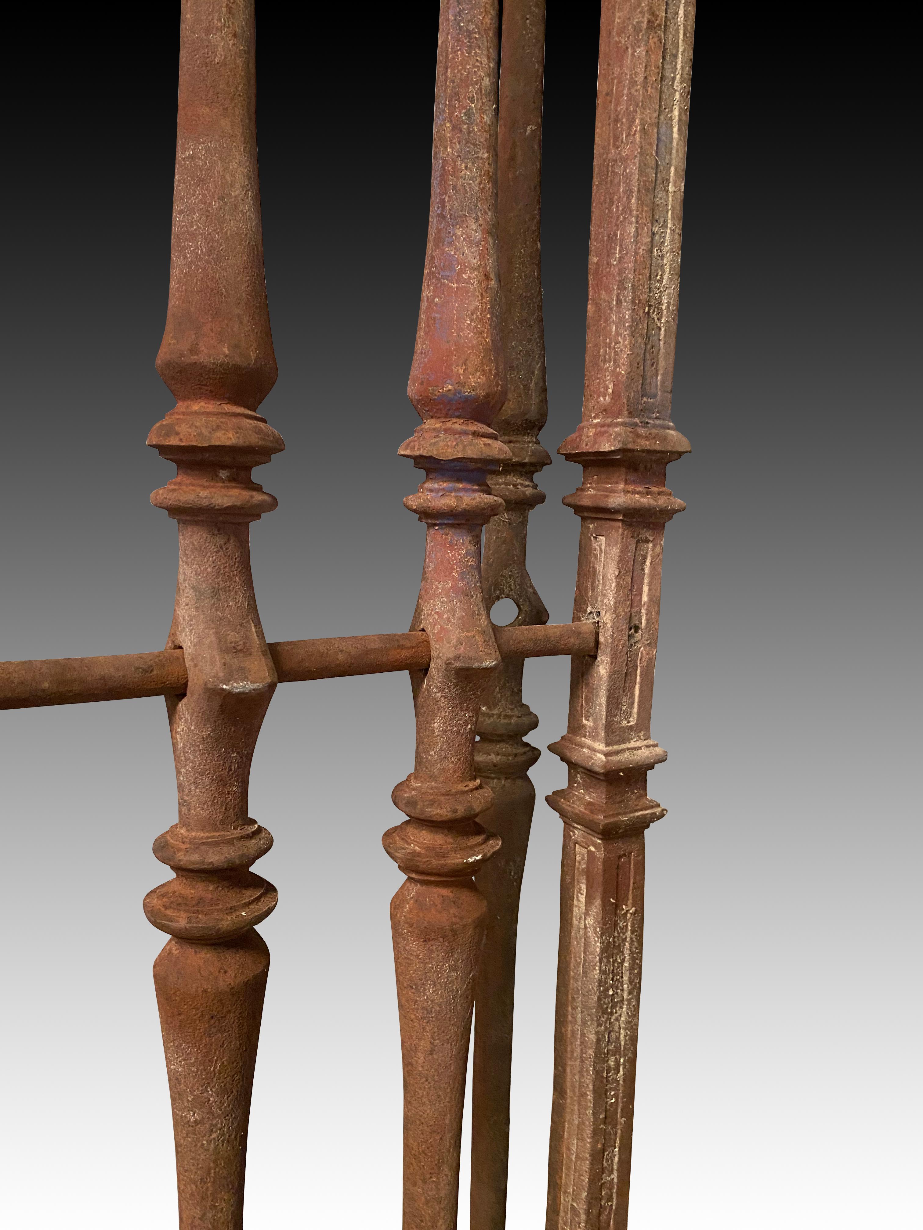 Portail avec passage. Fer forgé. Espagne, 17e siècle. 
Garde-corps rectangulaire en fer avec une balustrade à mi-hauteur, un cadre et des supports pour le maintenir debout. Les barres verticales ont des formes de balustrades opposées et une série de