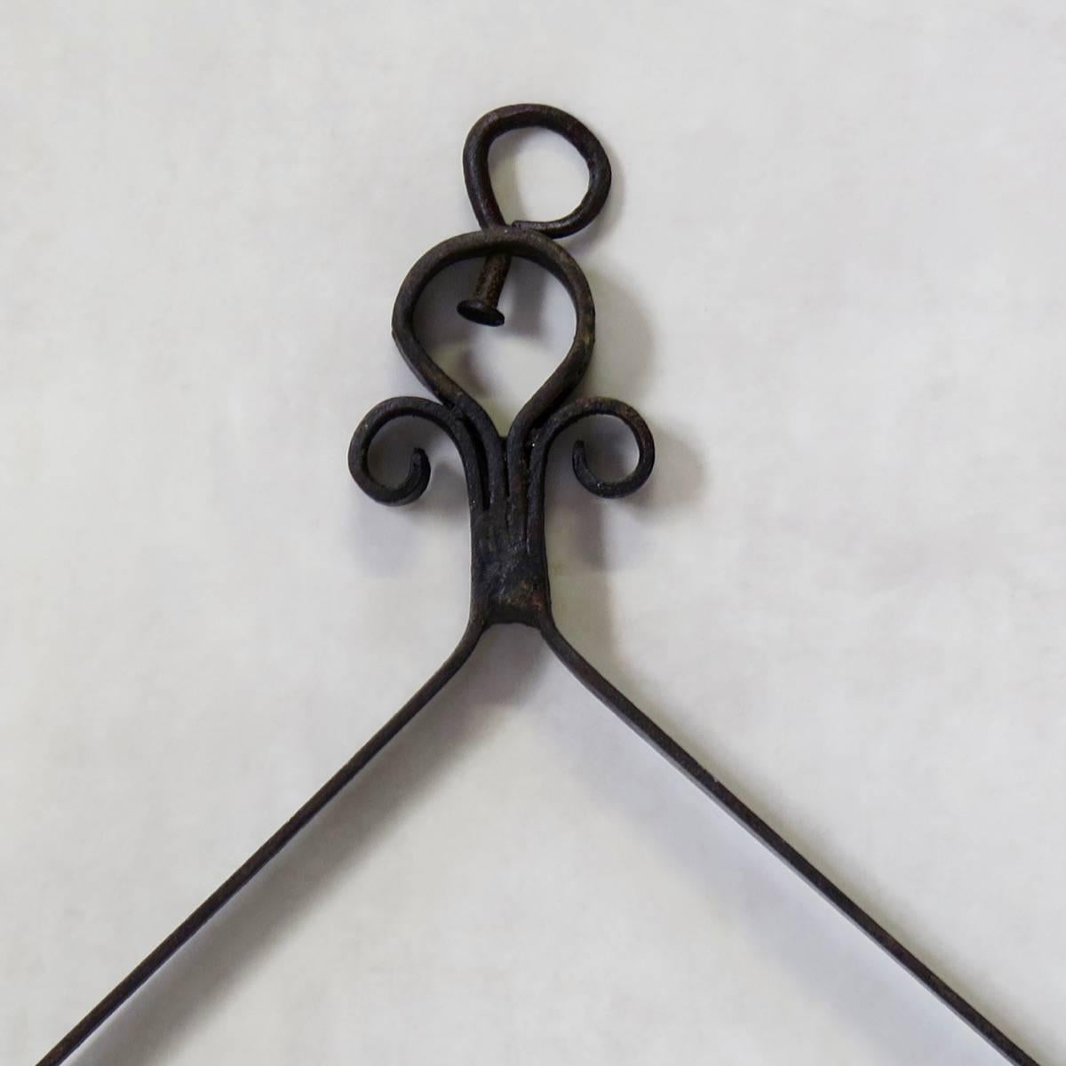 Unusual and decorative wrought-iron hanging candle holders. Ten available.