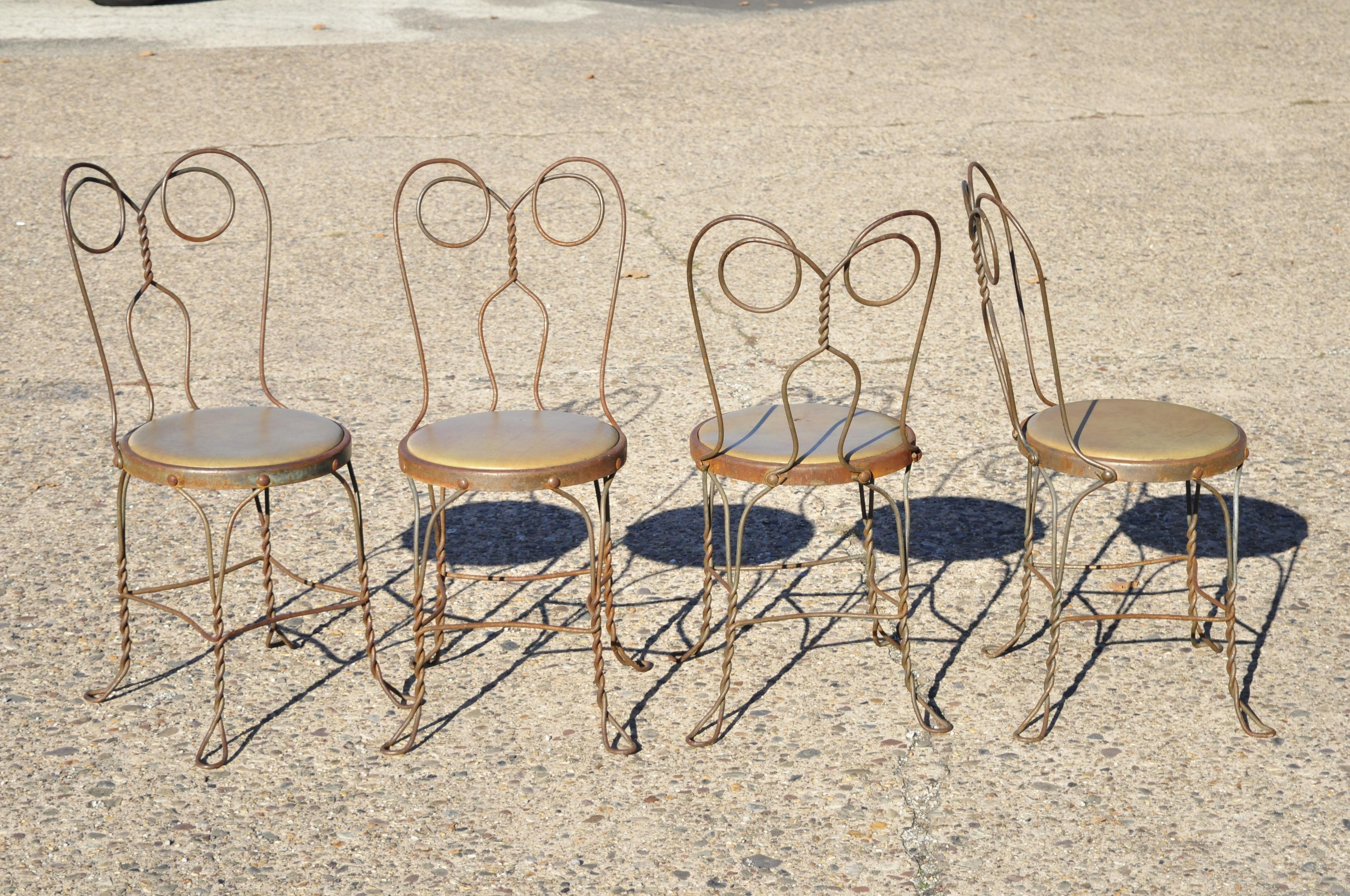 Antique twisted wrought iron ice cream parlor bistro dining chairs green distressed rusty finish - Set of 4. Item features round upholstered seats, wrought iron metal frames, distressed finish, very nice antique set, quality American craftsmanship,