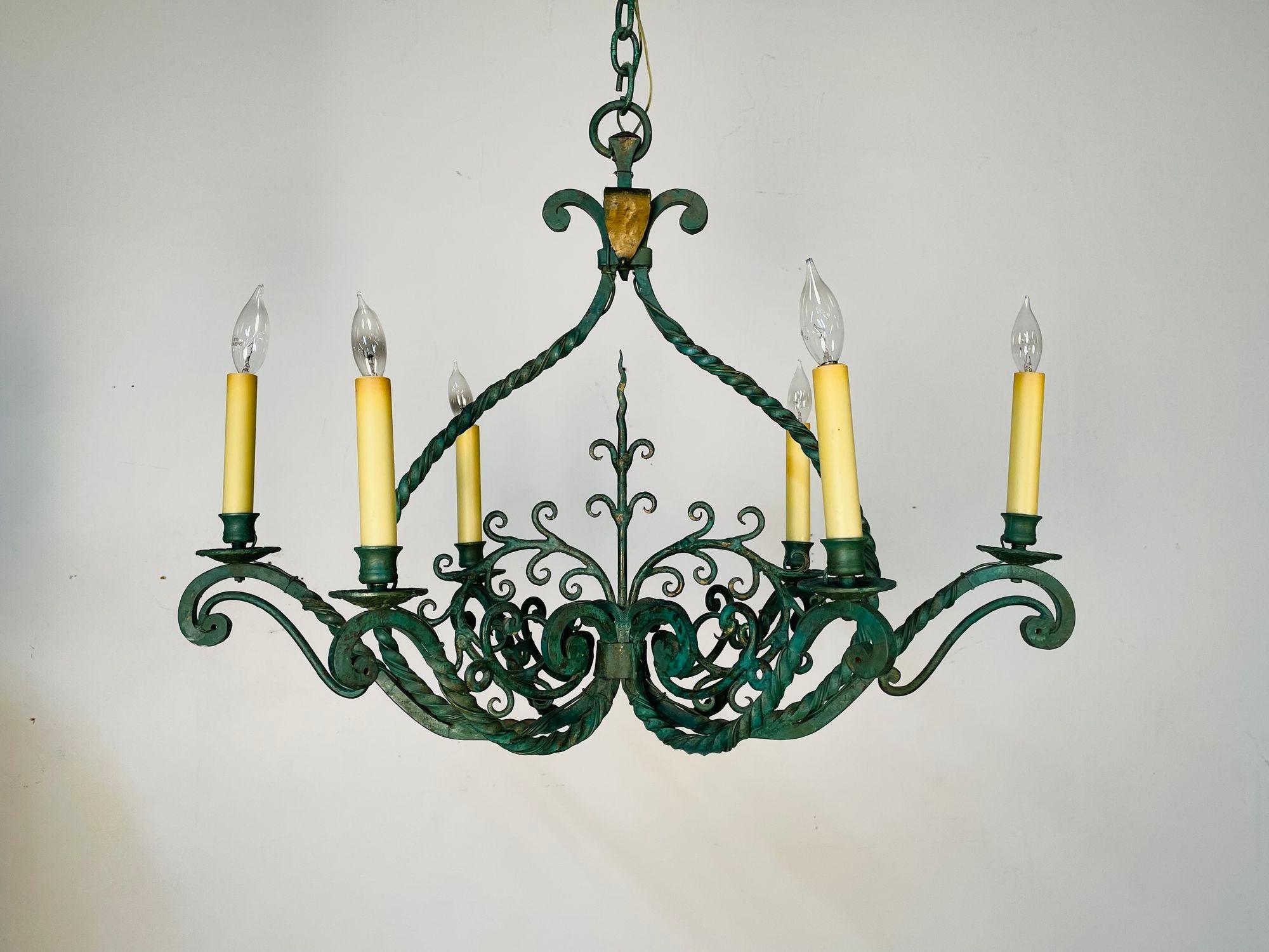 Wrought Iron Industrial Green Painted Chandelier, Circa 1930s

The whole of retangular form with scroll and vine design. Solid heavy metal in a nice rustic paint decorated green with brass undercoating. Having a matching 27 inch chain.

23H. 30W
