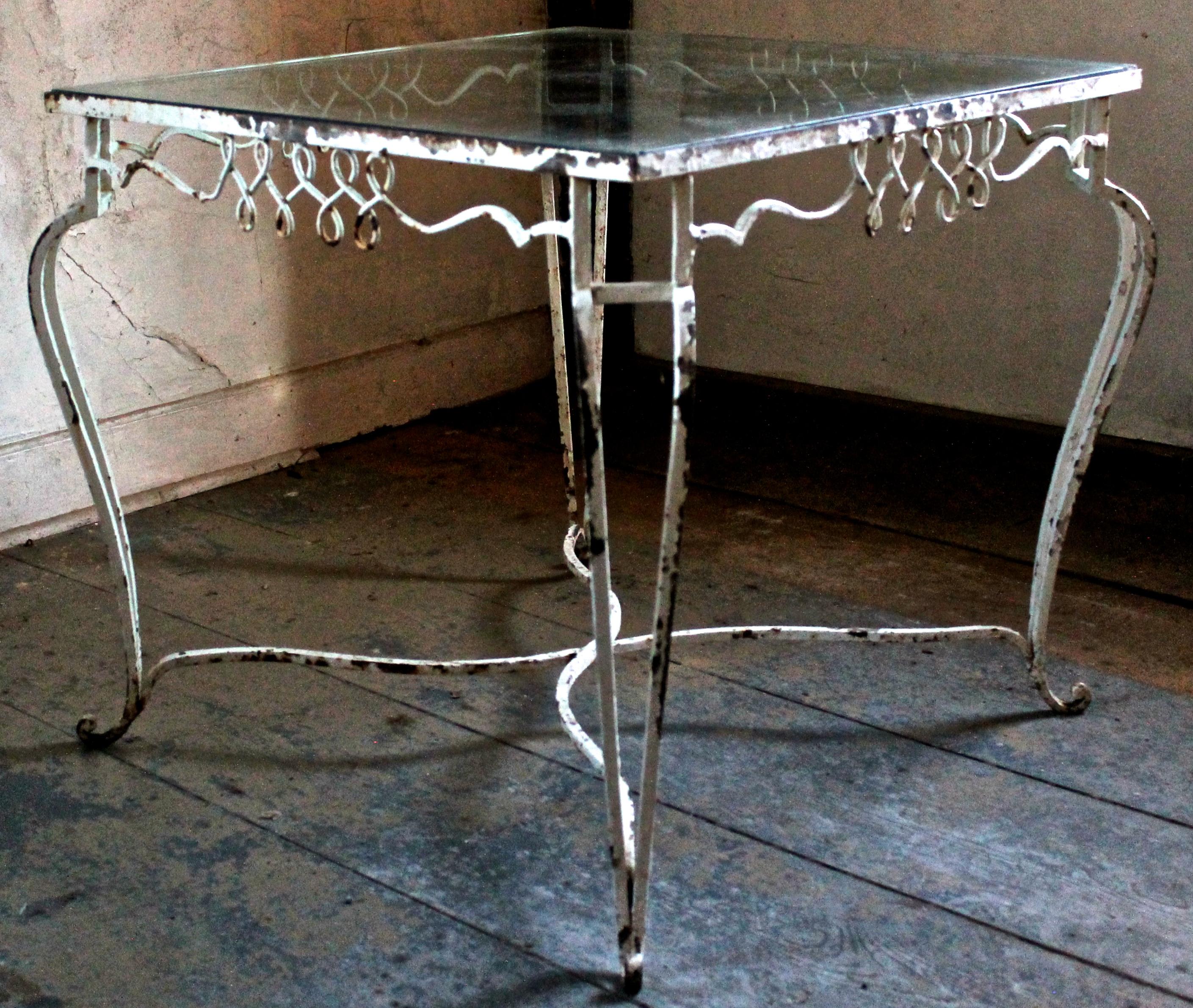 A French forties style wrought-iron table, in the manner of Jean-Charles Moreux. Old and thick glass: 31