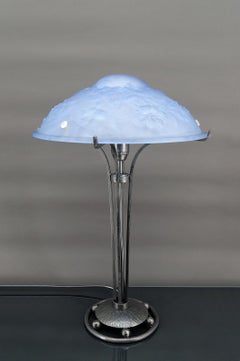 Wrought iron lamp with a blue glass lampshade with clematis and spider webs