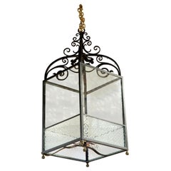 Wrought iron lantern with frosted panels to lower part