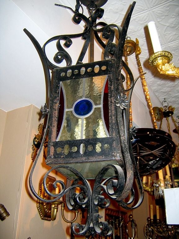 A French circa 1920s wrought iron lantern with leaded glass insets. 

Measurements:
Height 35