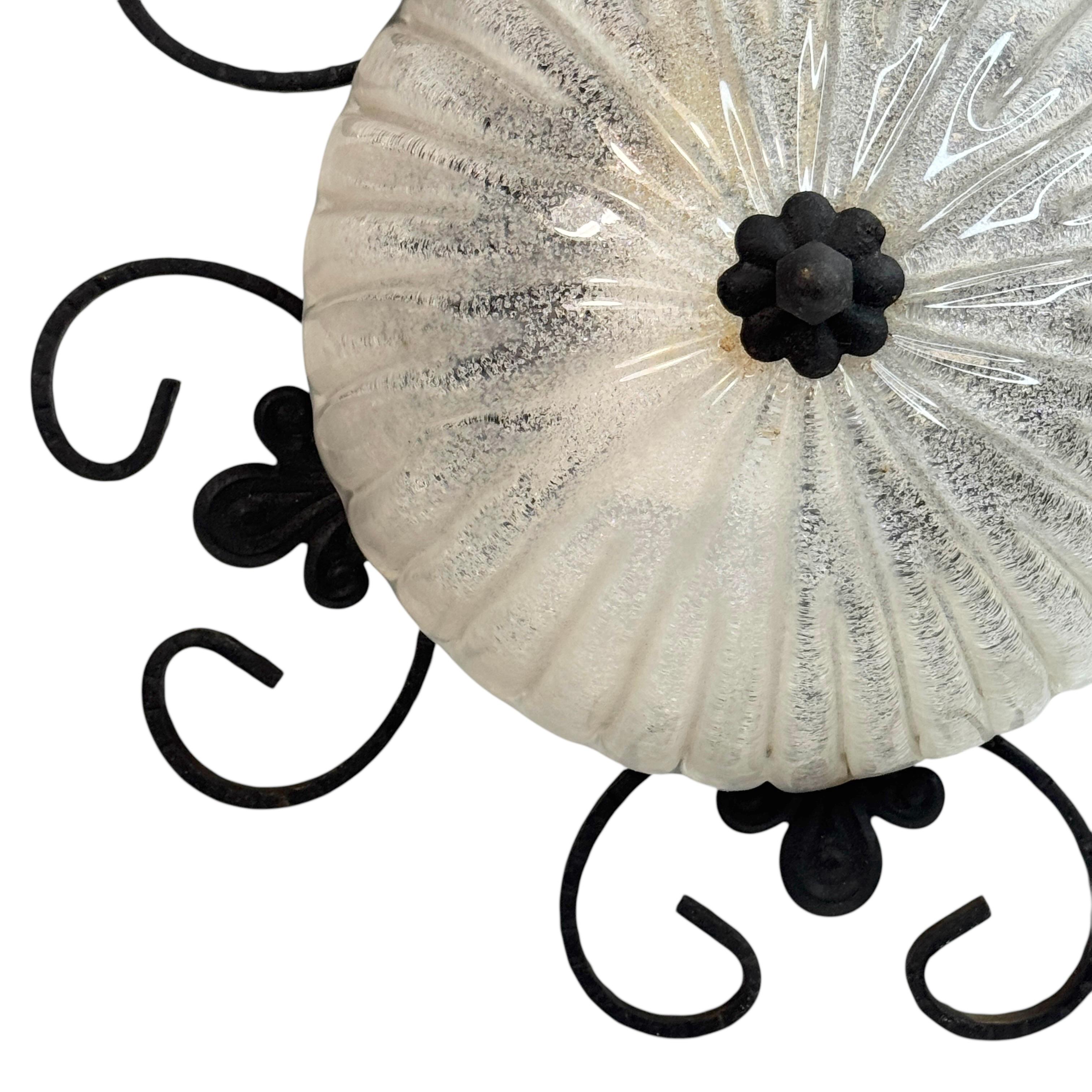 A beautiful flush mount made of wrought iron with an murano ice glass shade. Gorgeous textured glass flush mount with metal fixture. The fixture requires one European E27 Edison or medium bulb up to 60 watts. A nice addition to any room or hall