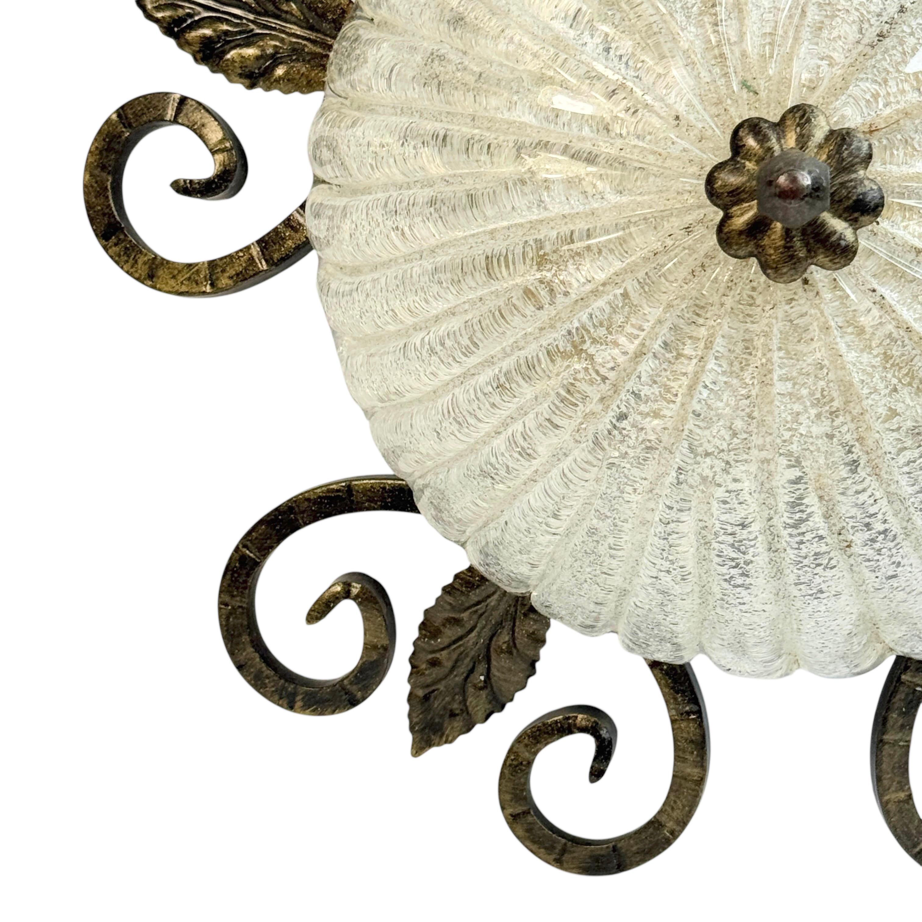 A beautiful flush mount made of wrought iron with an murano ice glass shade. Gorgeous textured glass flush mount with metal fixture. The fixture requires one European E27 Edison or medium bulb up to 60 watts. A nice addition to any room or hall