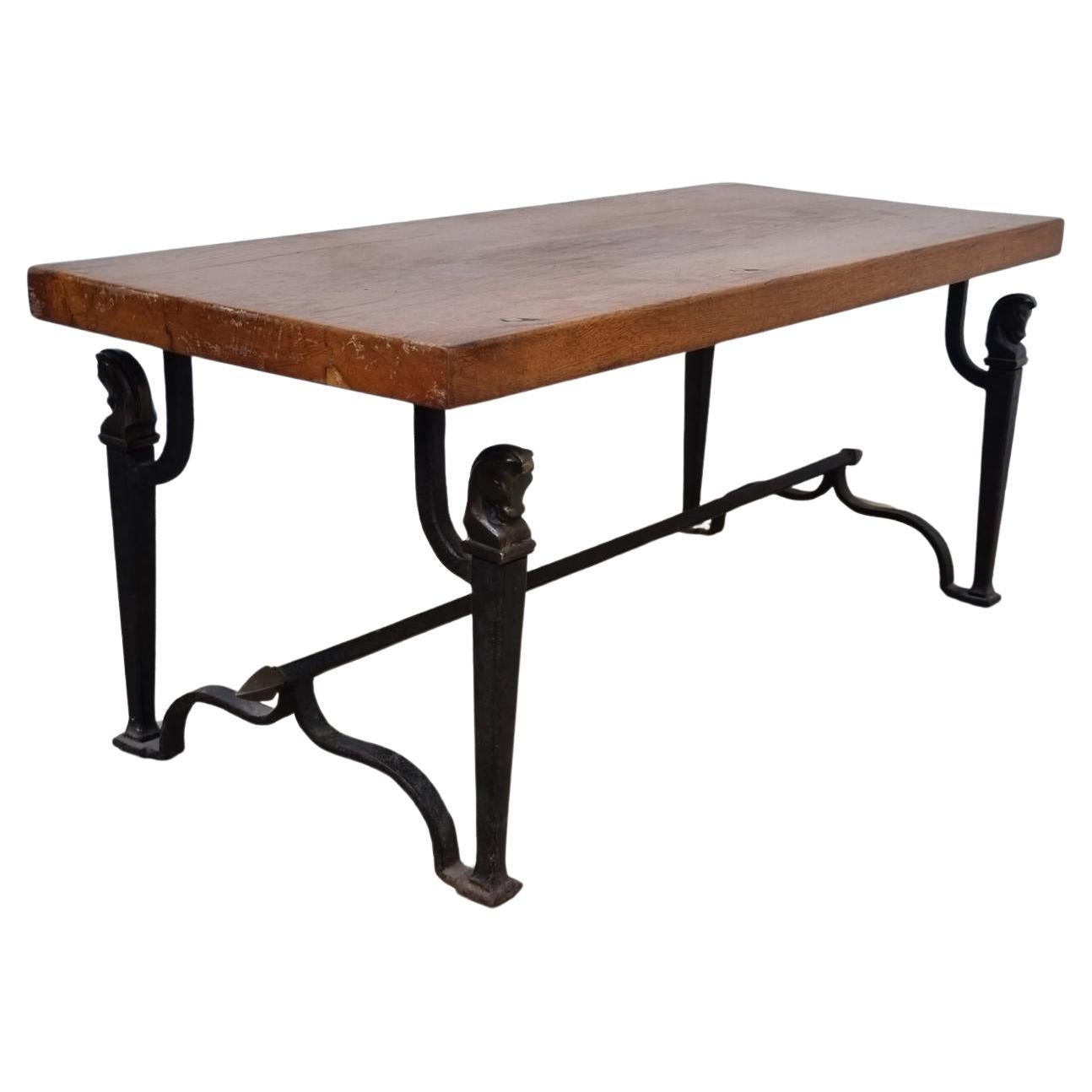 Wrought iron living room table decorated with horse heads, solid oak top circa 1