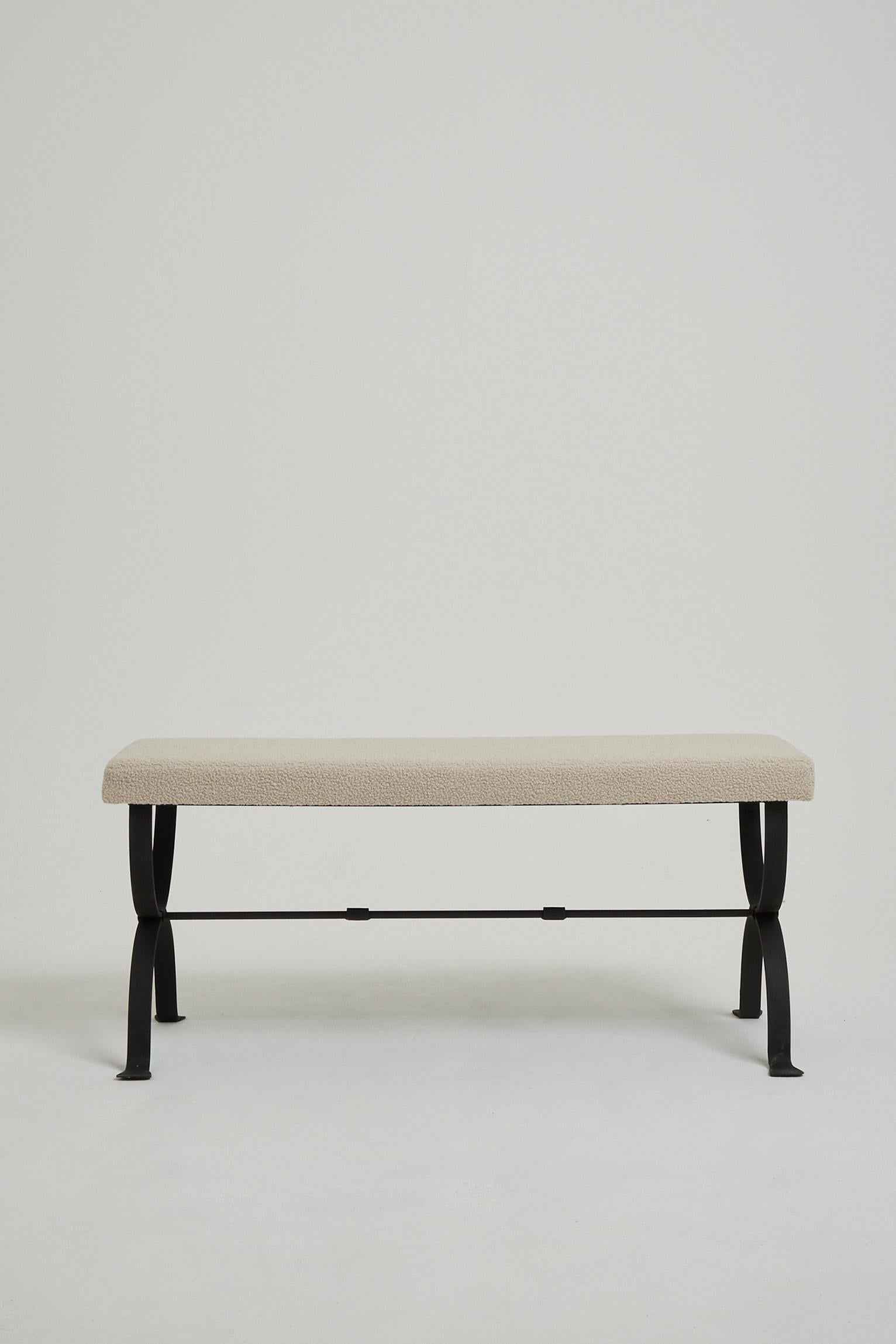The 'Mahón' long stool, by Dorian Caffot de Fawes.
Black enamelled forged iron frame, upholstered in bouclé fabric. 
Hand made in Spain, upholstered in London.