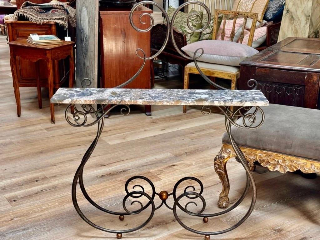 A Wrought Iron Marble Top Console Table with gilt details;  20th Century in the style of René Prou.  Height 46 1/2 x width 39 1/2 x depth 8 1/2 inches.

