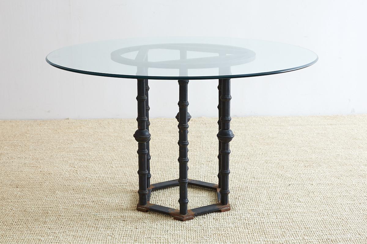 Dramatic wrought iron dining table or garden table featuring six columns decorated with a Moorish or Middle Eastern design. This bespoke table has a very solid and heavy base that could support any size glass or marble top. Made in a whimsical style