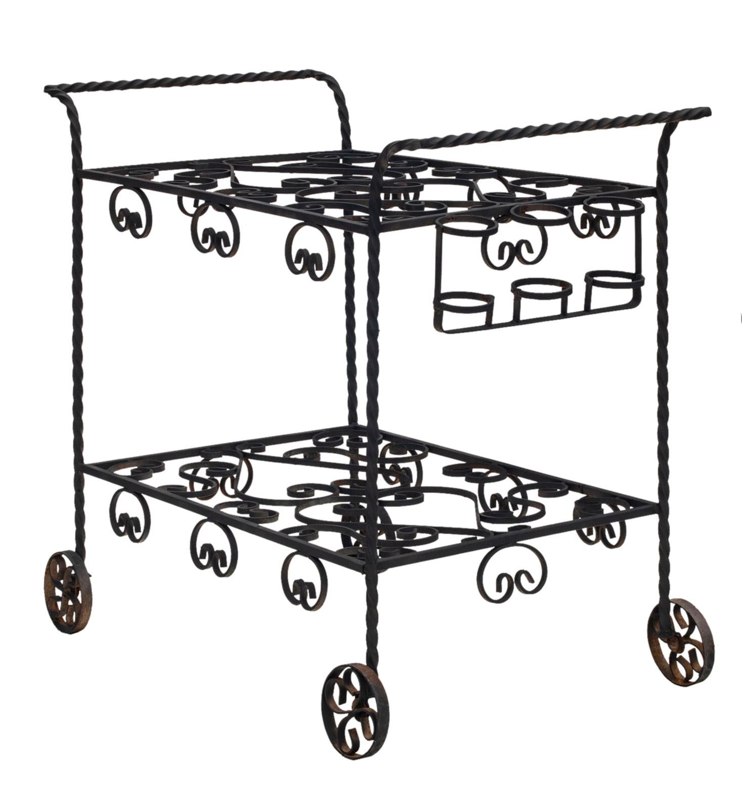 Vintage wrought iron garden bar cart featuring a decorative lower tier with scrollwork.
Quality American craftsmanship made in the '40's with great style & form. 
Decorative wheels for mobility.
Refinished in matte black.
Optional plexiglass tops.
