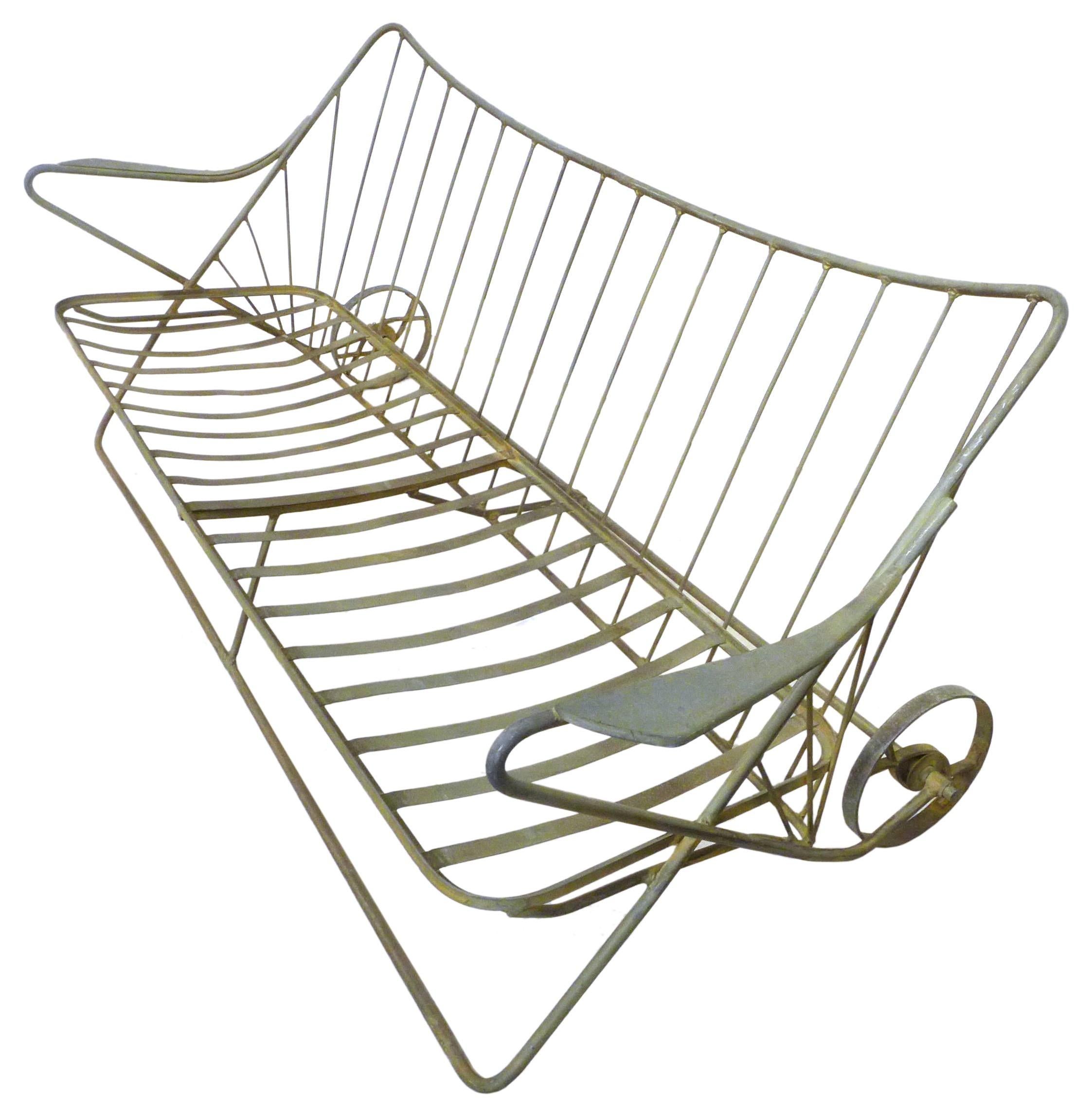 A wonderful, wrought iron, outdoor sofa frame by John Salterini. Quintessential Salterini spirit with elegant, swooping lines, great proportions and quality construction. Original rear wheels add a nice detail and ease of mobility. A much-desired,
