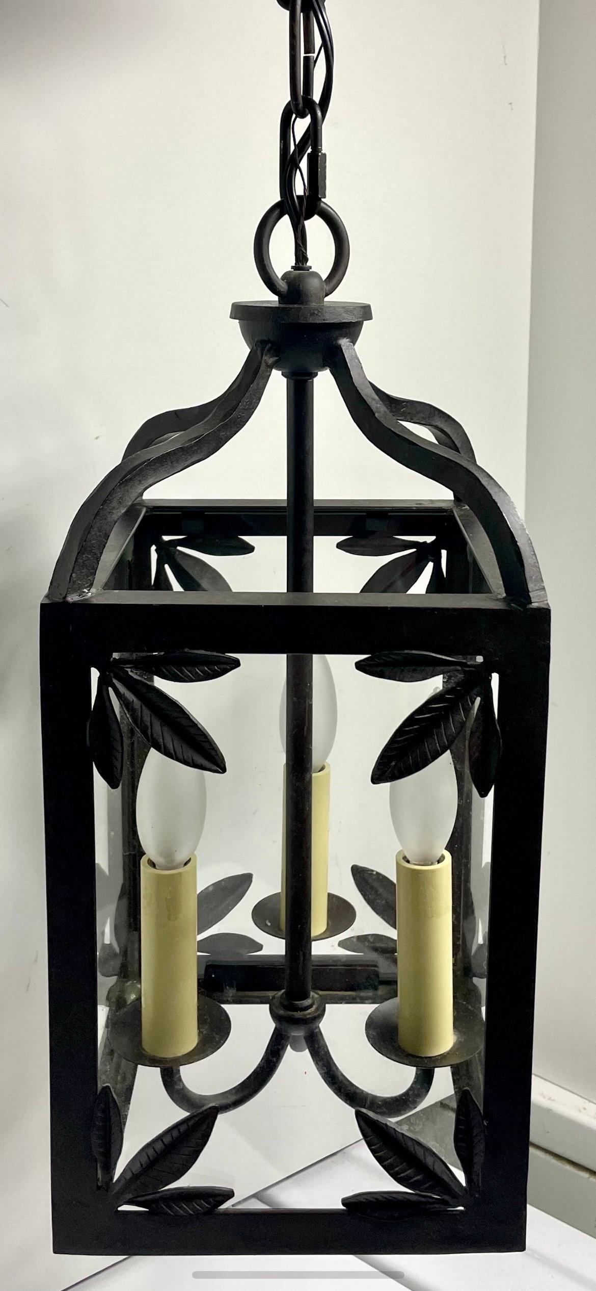 Handmade Heavy Wrought Iron Palm Leaf Chandelier with three lights. Glass panel sides with four sets of three leaves on each of the four sides  Measure 18