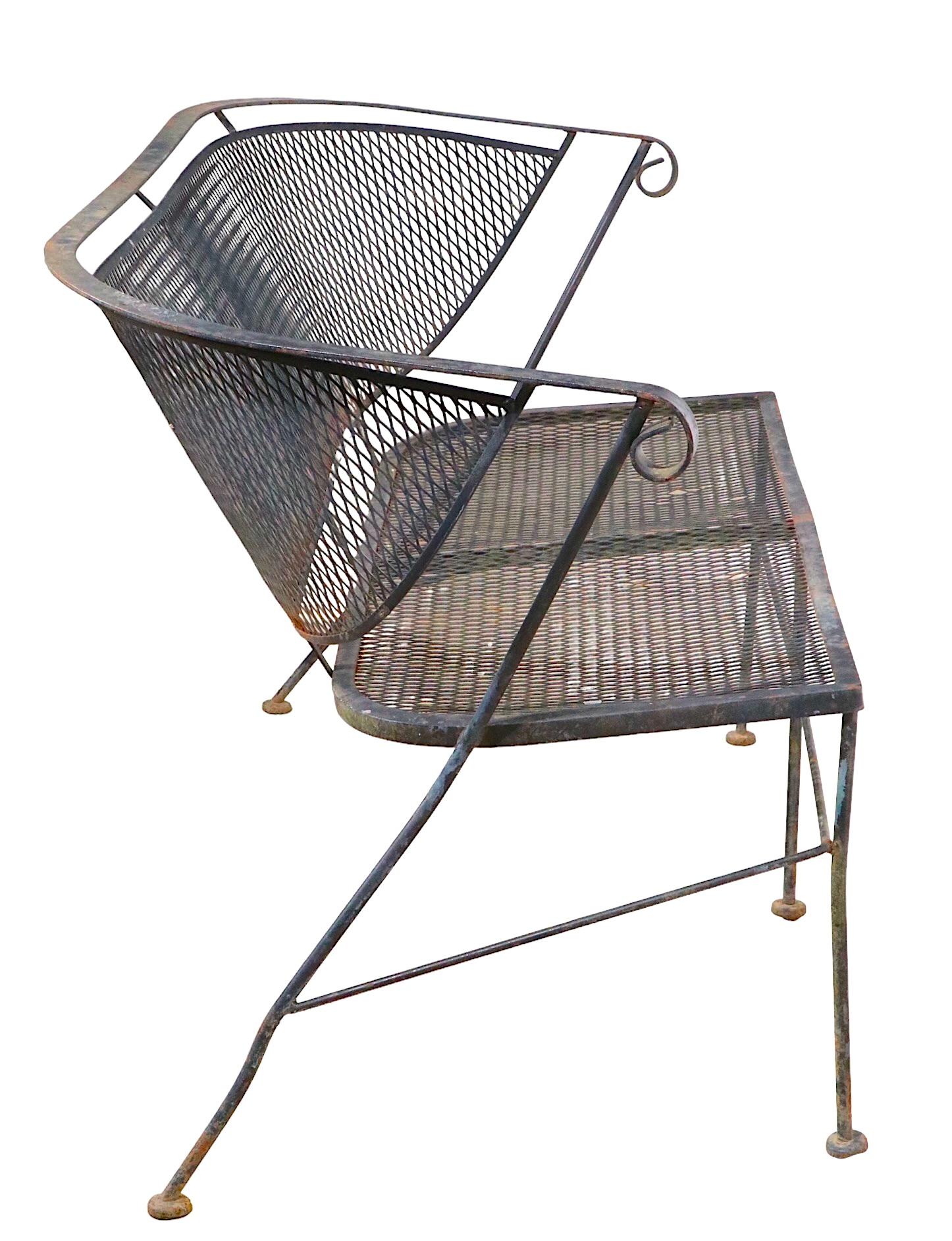 Stylish wrought iron settee, loveseat, sofa, attributed to Salterini, in the style of Woodard. The loveseat is in very good, original condition, showing only light cosmetic wear, normal and consistent with age.
