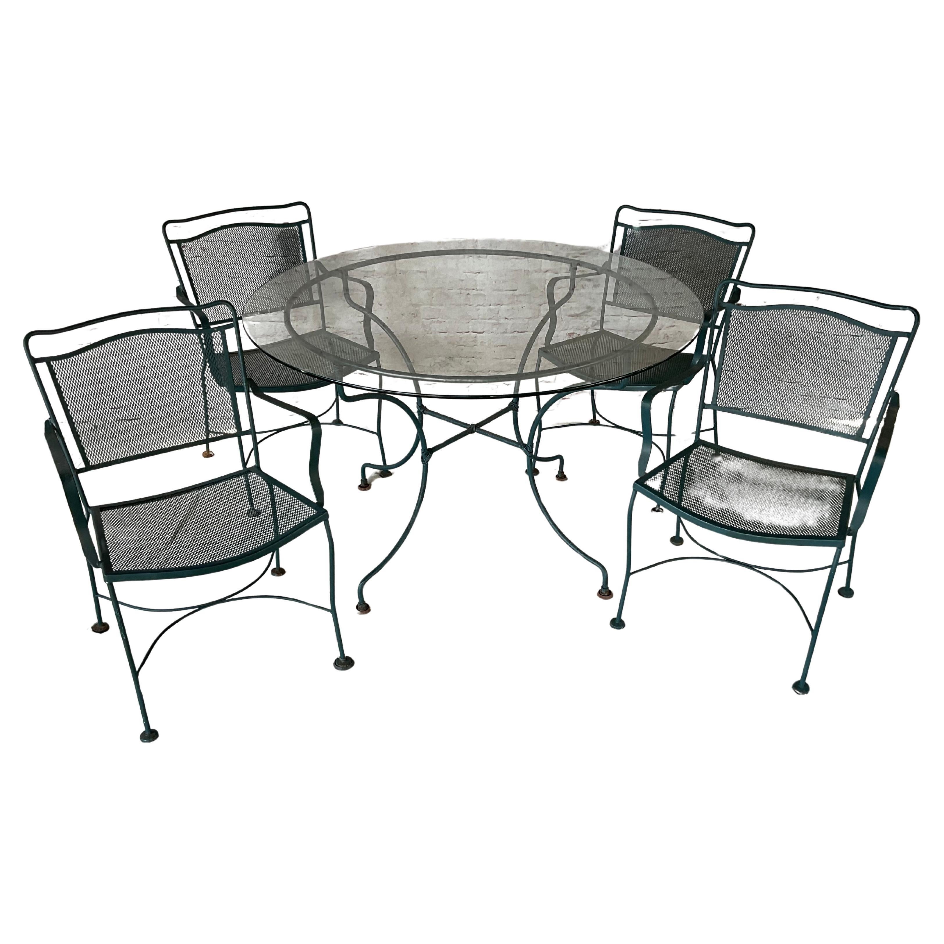 20th Century Wrought Iron Patio Table and Four Chairs, A Five Piece Set For Sale