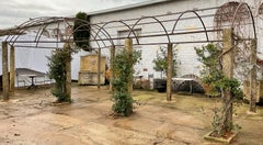 Wrought iron pergola with granite monolith pillars