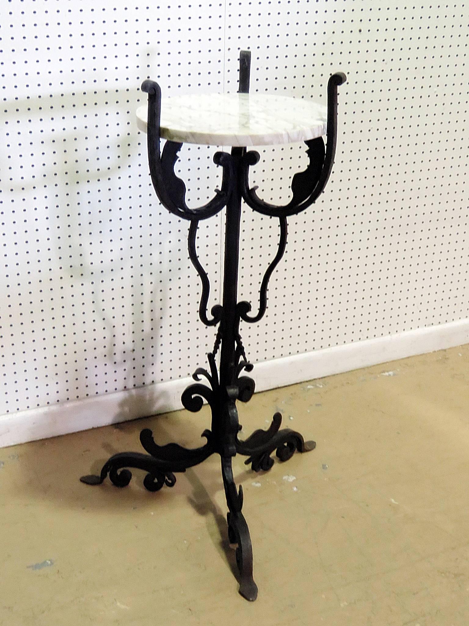 Wrought iron plant stand with inset marble top attributed to Samuel Yellin.