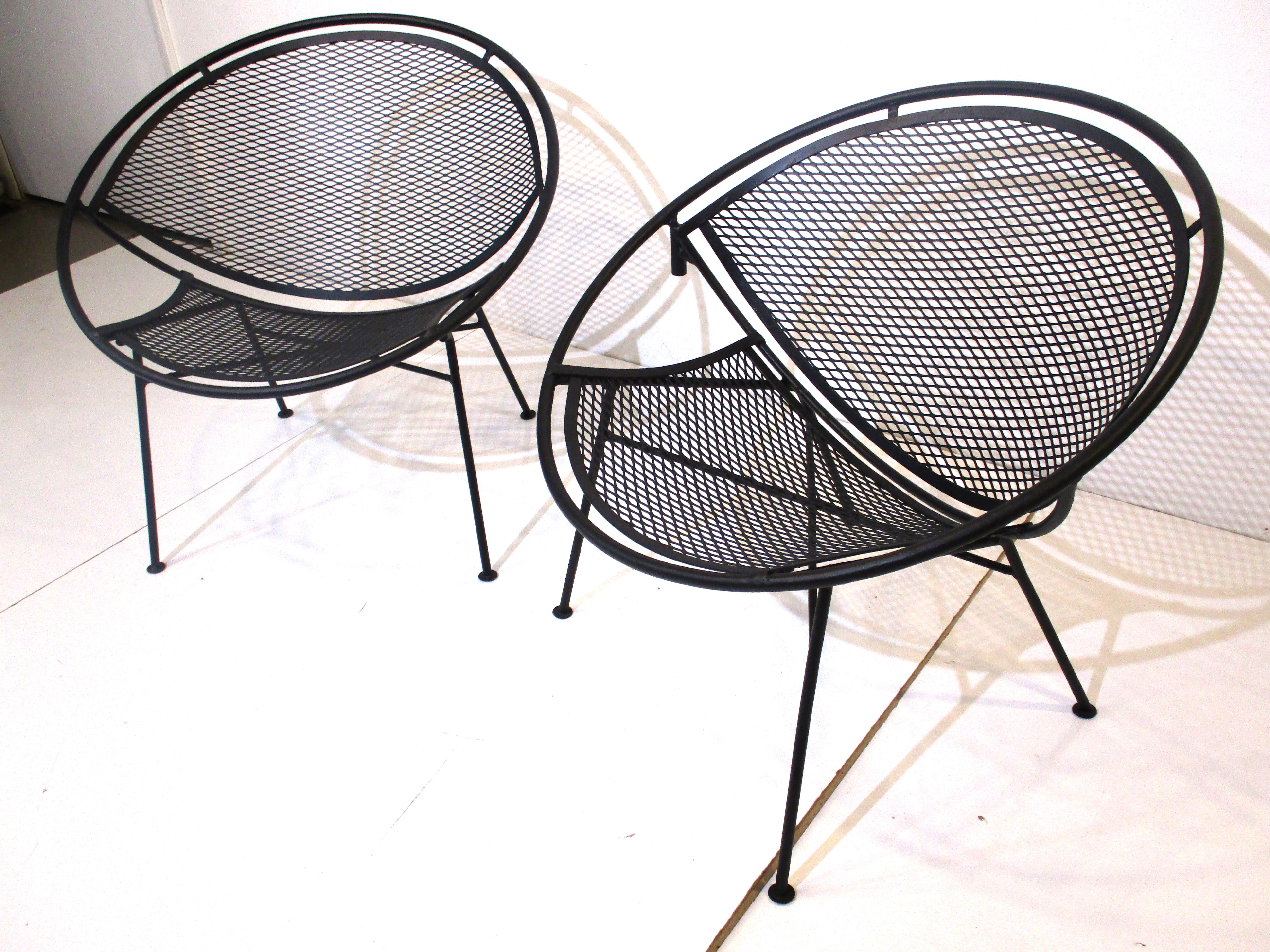 A pair of satin black Radar wrought iron lounge chairs designed by Maurizio Tempestini. The perfect Midcentury chairs for your patio or three seasons room giving you maximum comfort are well crafted and sturdy, manufactured by John Salterini.