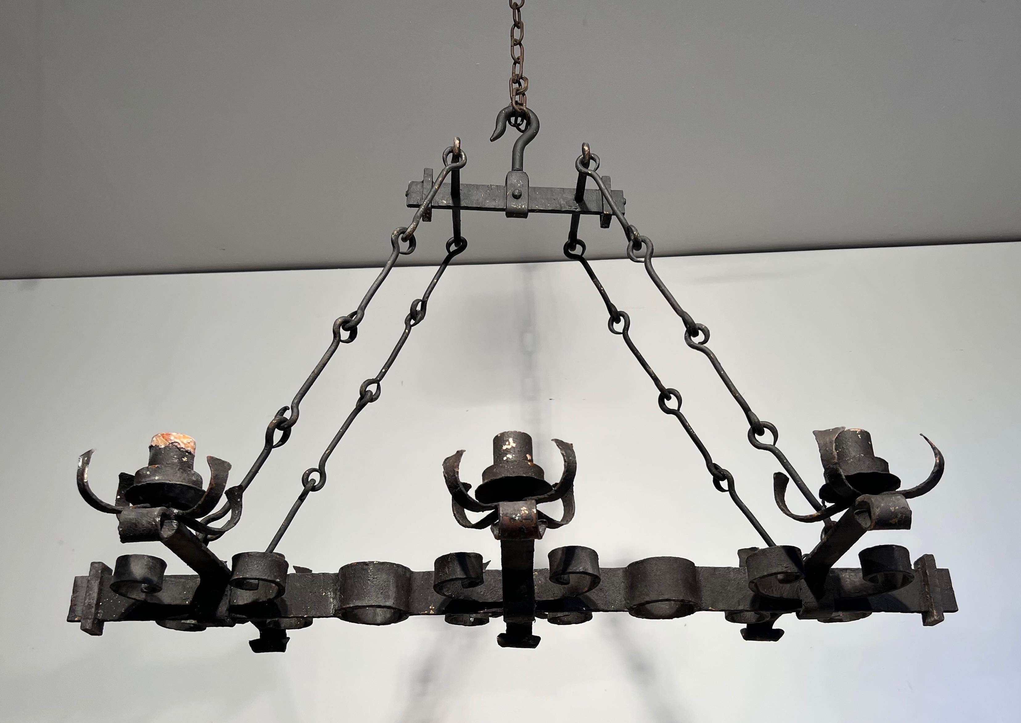 This rectangular chandelier with 6 arms is made of wrought iron. This is a French work in the Gothic style. Circa 1950