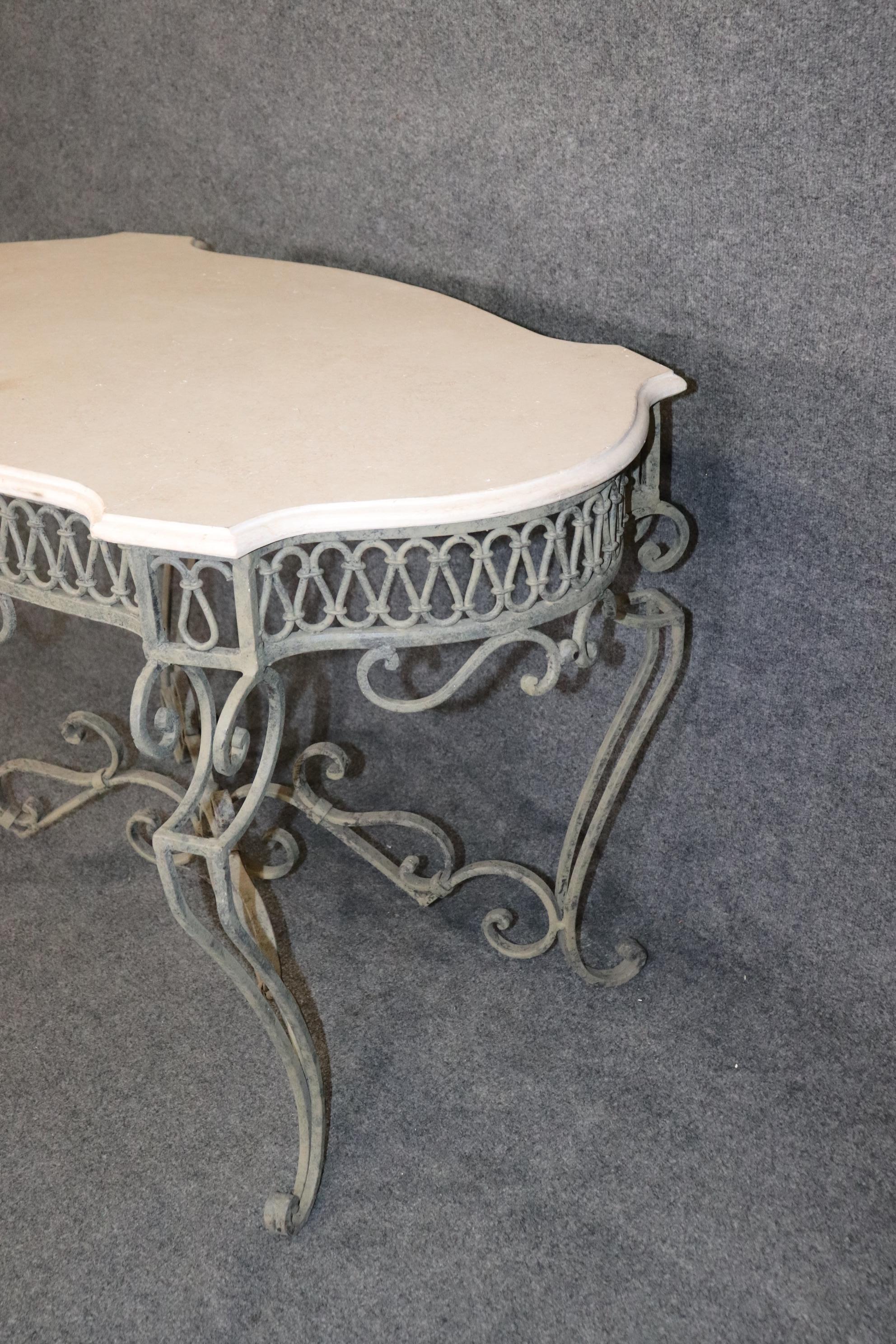 Dimensions- H: 31in W: 47 1/2in D: 27 3/4in 

This Vintage Wrought Iron Regency Style Travertine Top Center Table is truly incredible and is made of the highest quality! If you look at the photos provided, you can see the distressed wrought iron