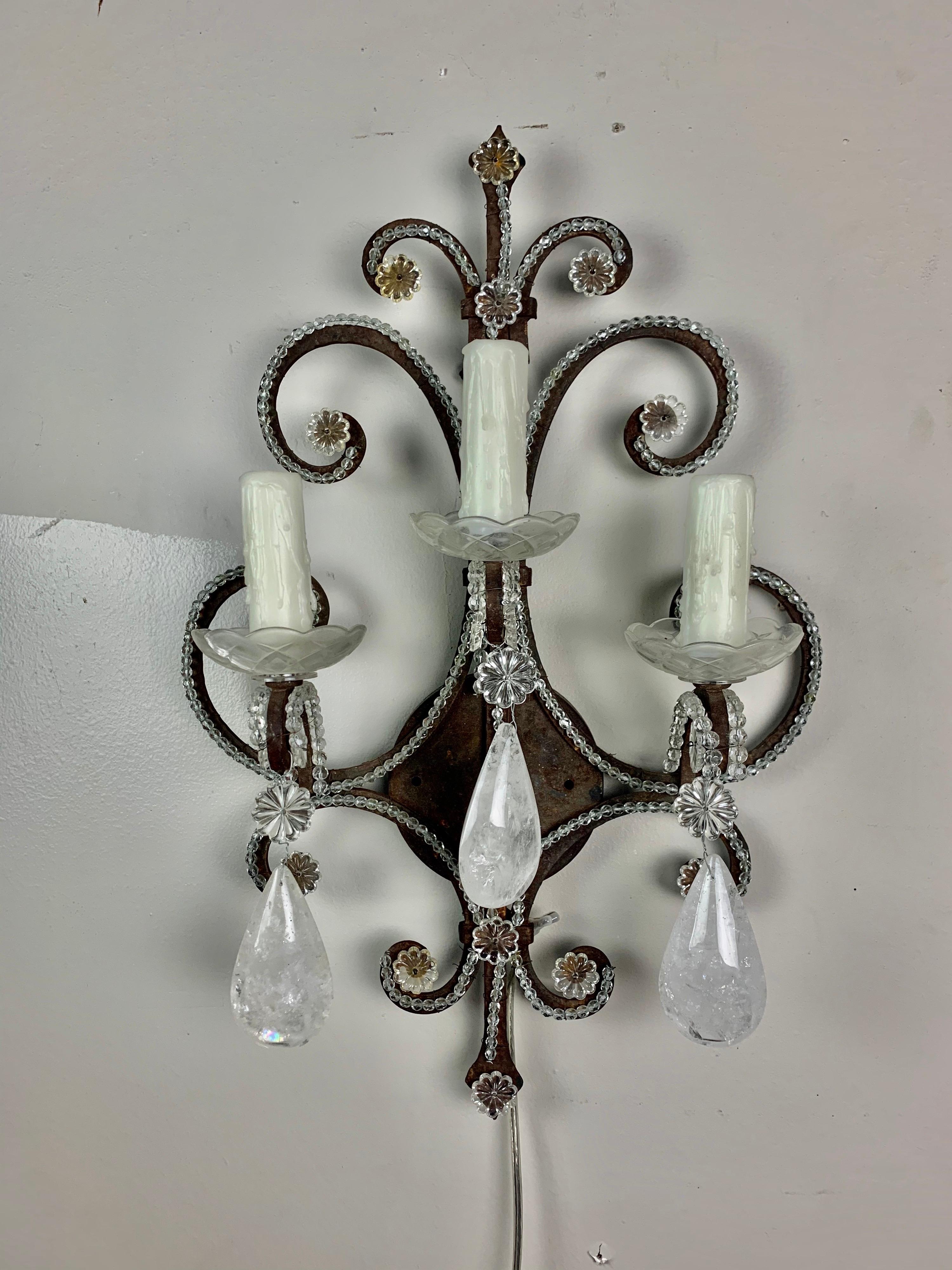 3-light wrought iron and rock crystal sconces with almond shaped rock crystals.