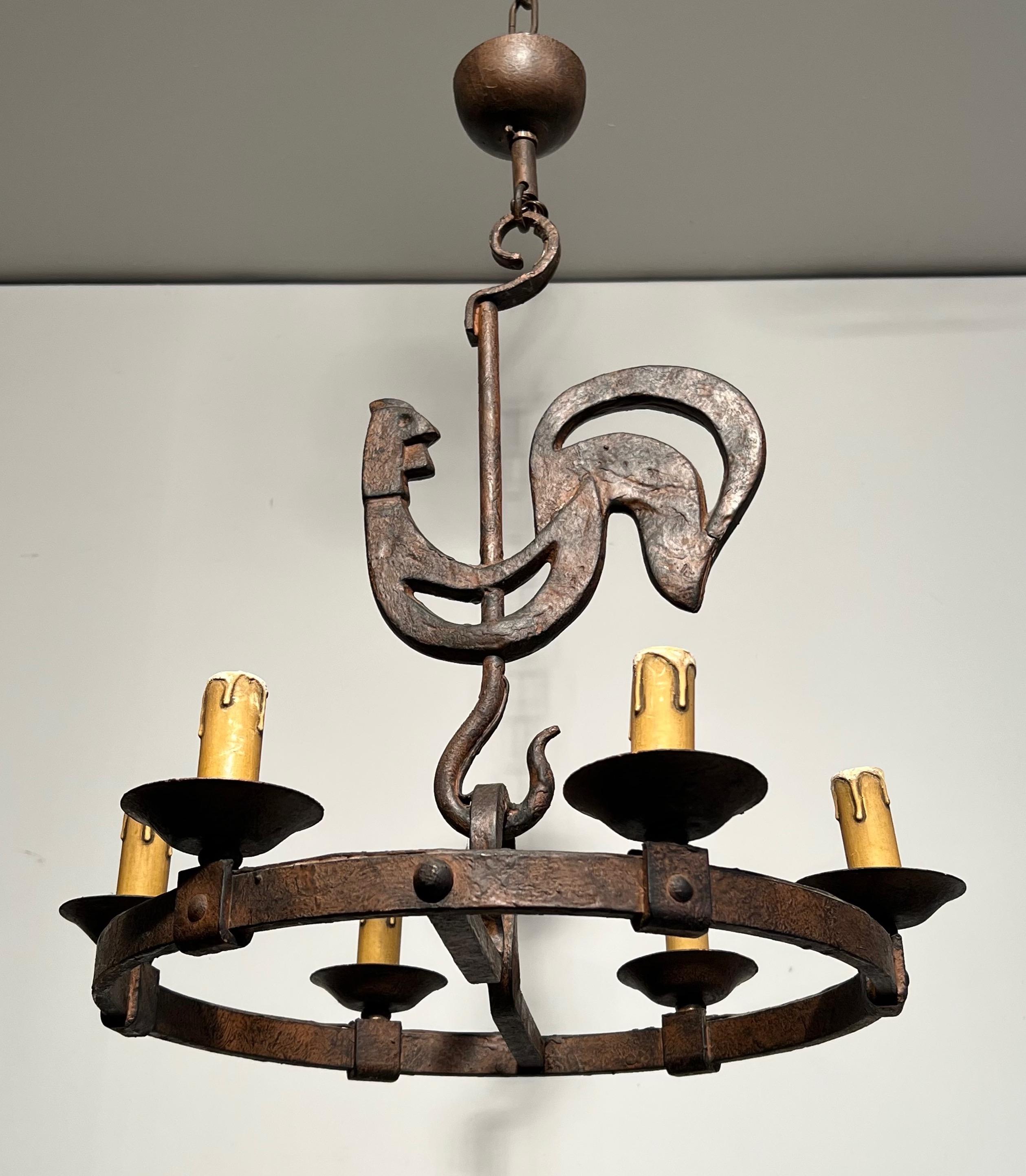 This very nice and stylished chandelier with a rooster is made of wrought iron. This isa French work by Jean Touret for Atelier Marolles. Circa 1950