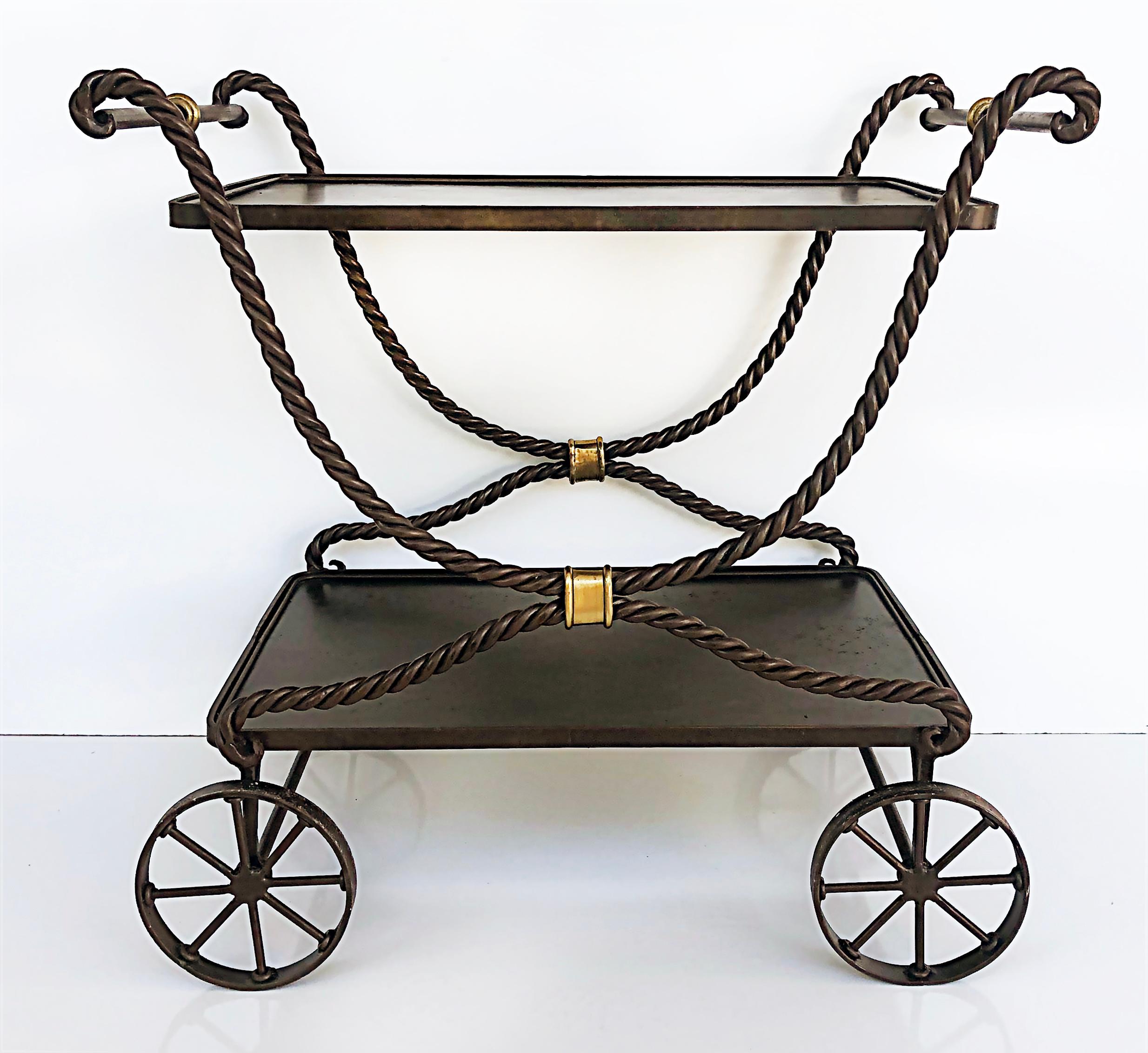 Wrought iron rope bar cart tea trolley Maitland Smith attributed.

Offered for sale is a Maitland Smith attributed wrought iron twisted rope bar cart or tea trolley with wheels. The wrought iron has brass accent details. The wheels are quite