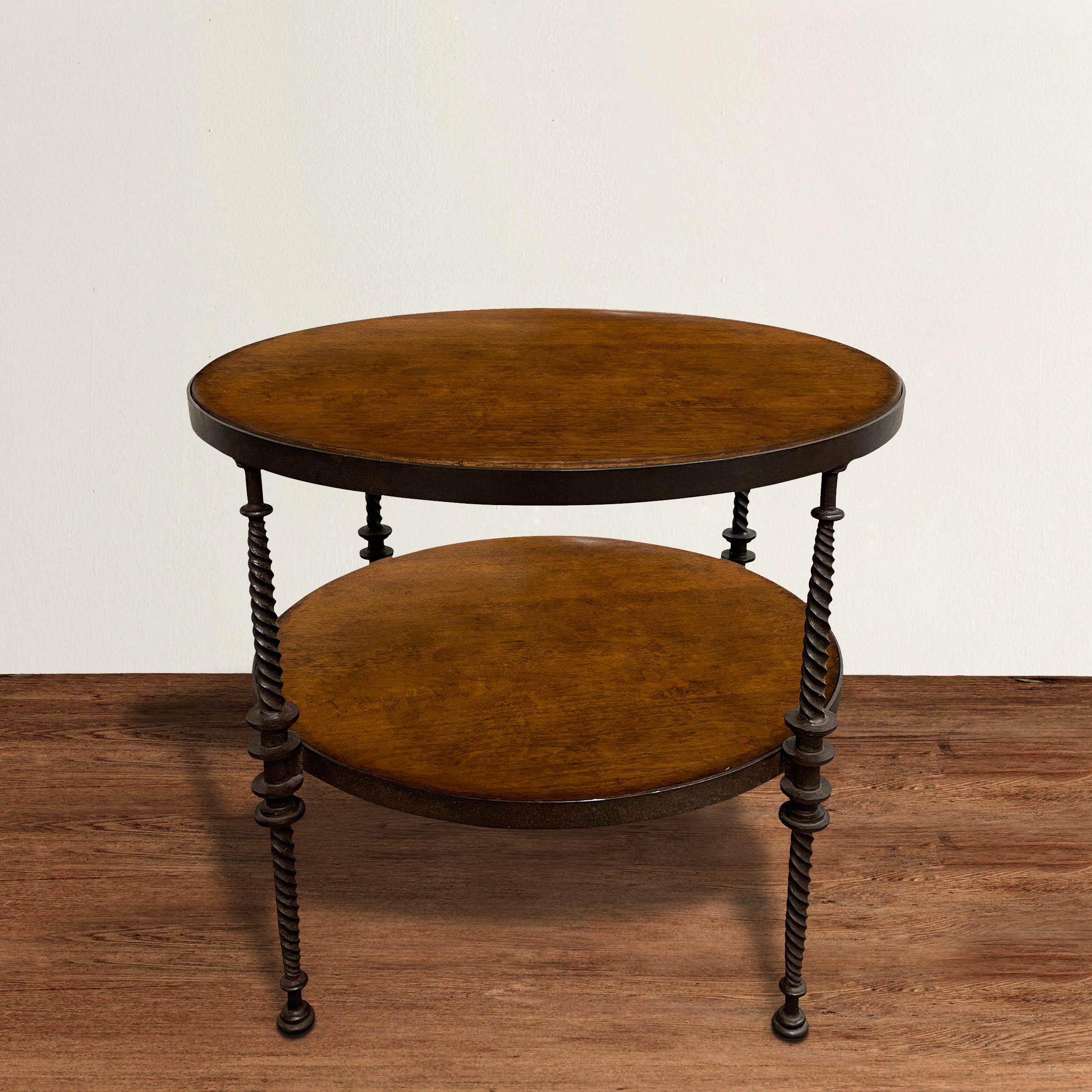 A stunning 20th century round side table with hand-wrought iron barley twist legs with bun feet and a walnut top and shelf. Perfect next to your sofa or your bed.