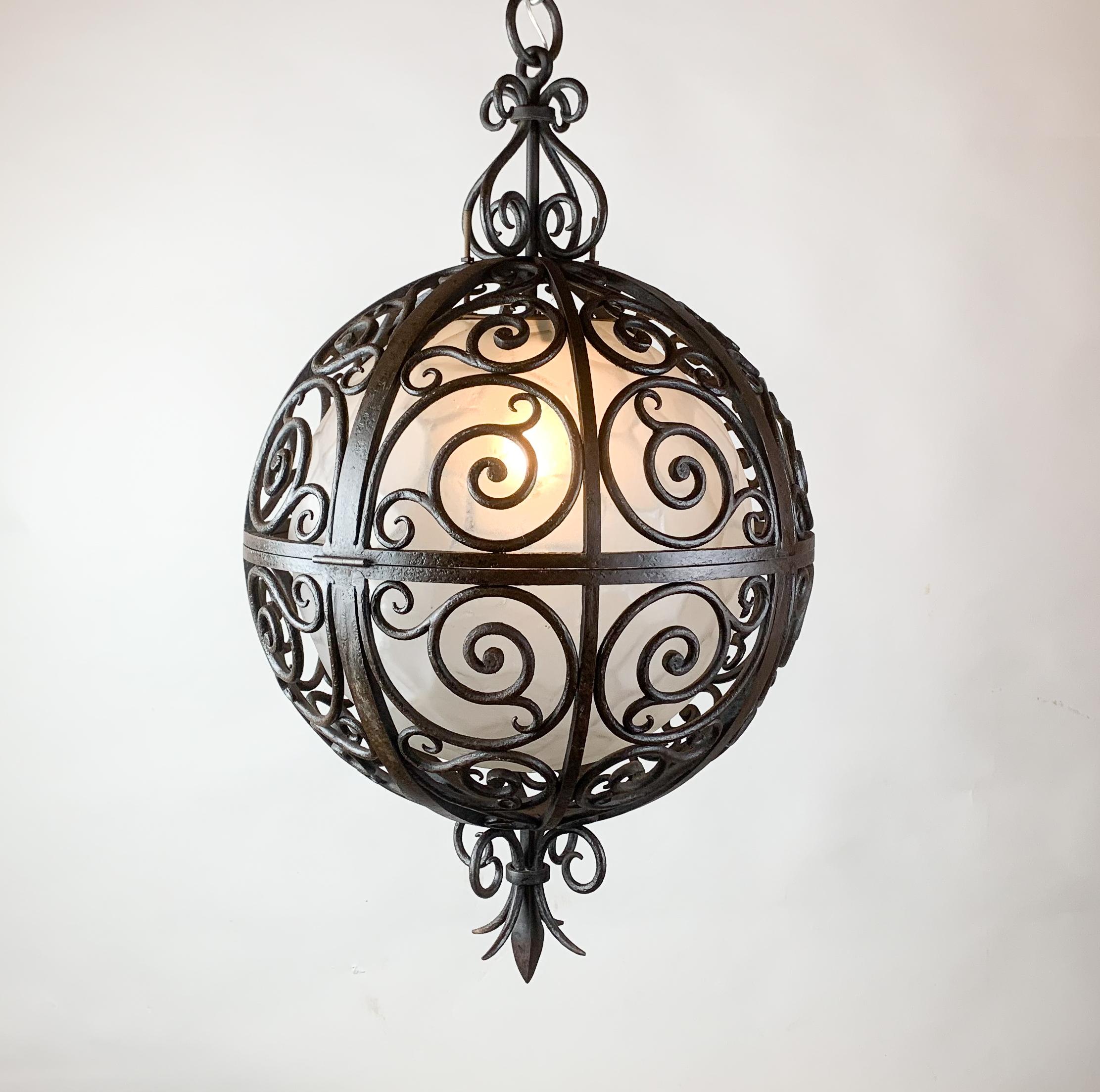 Wrought iron round suspension with interior glass sphere - c.1930.