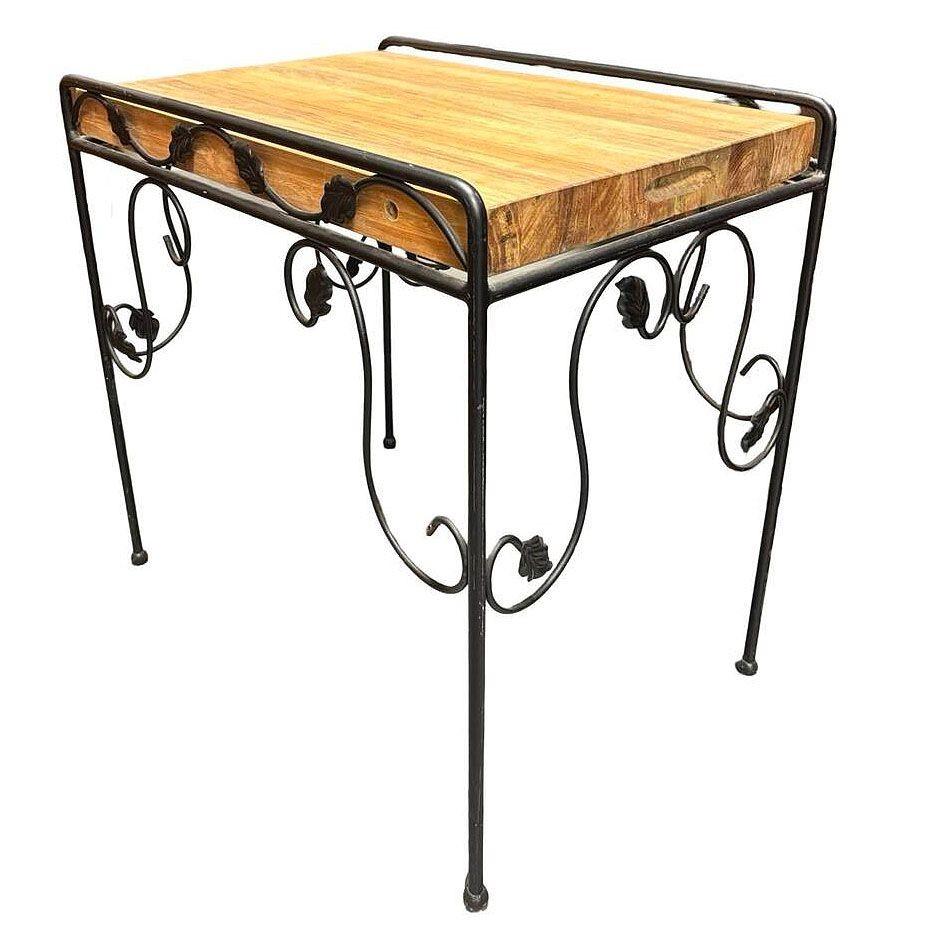 Elevate your patio with this striking wrought iron Butcher Block side table. The scrolling iron base showcases graceful curves and intricate ivy detailing, lending a timeless elegance to the piece. Atop the sturdy frame rests a butcher block-style
