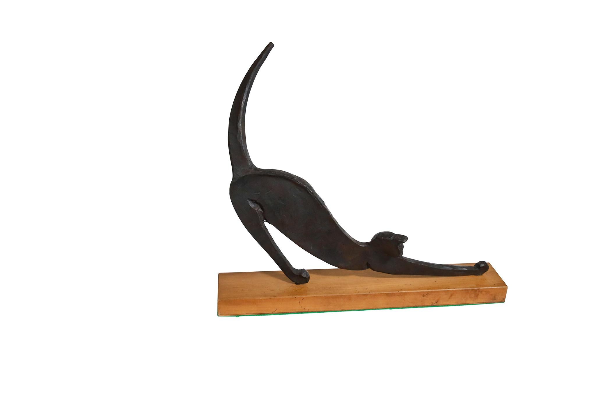 Wrought Iron Sculpture of Cat Stretching with a wooden base. Circa 1970.

Dimensions: 13 1/8
