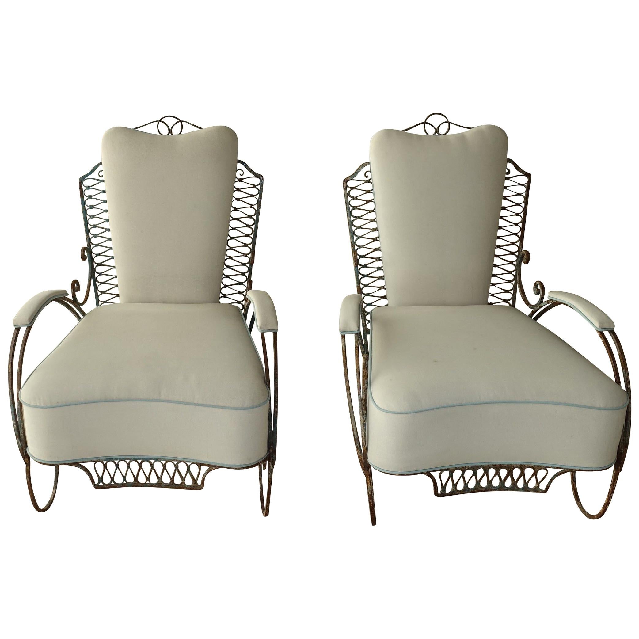 1940s French wrought iron settee and matching pair of chairs with very decorative iron work.
These pieces have a very beautiful natural weathered patina.
Upholstered in off-white outdoor fabric with pale turquoise piping. Foam filling.
Settee