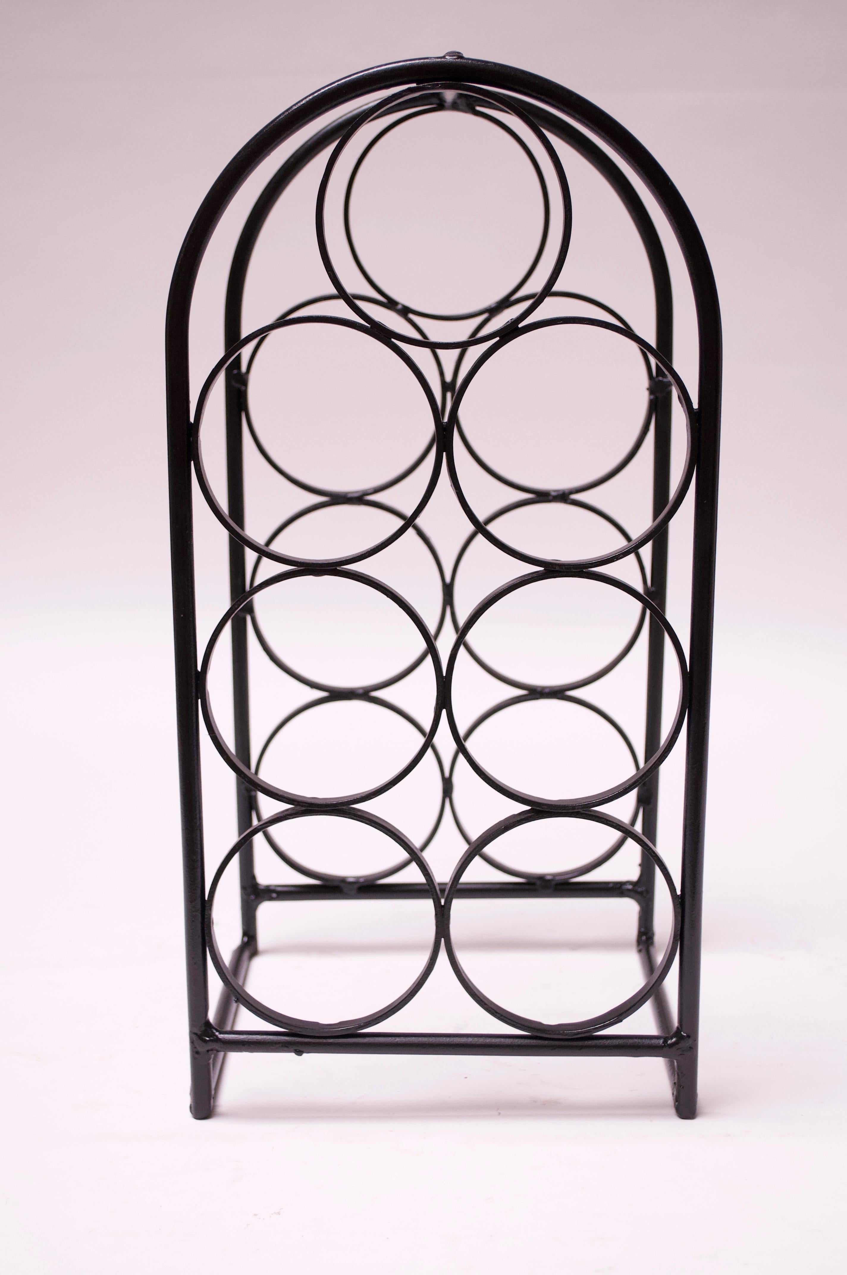 Arthur Umanoff wine rack (1950s USA) in painted wrought iron. Tabletop version, accommodating 7 bottles.
Pictured with this wine rack is the larger, 17-bottle holder (each sold separately).