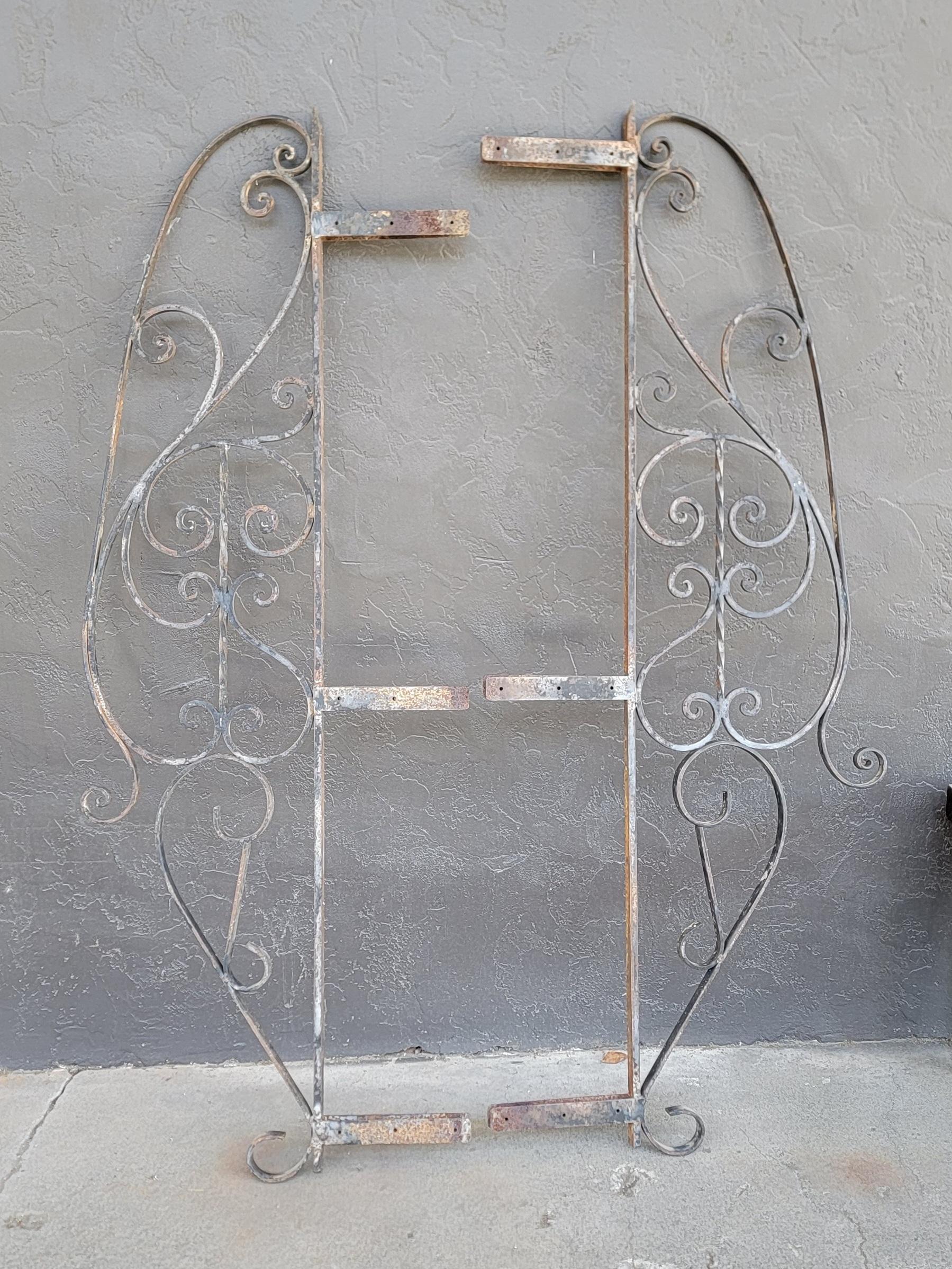 A pair of hand wrought iron panels. Appear to date from the early 1900's. Original use possibly as sides to an iron gate or window. Nice patina to iron. Measurements are for iron work only and does not account for mounting brackets. 

Each:
17.63