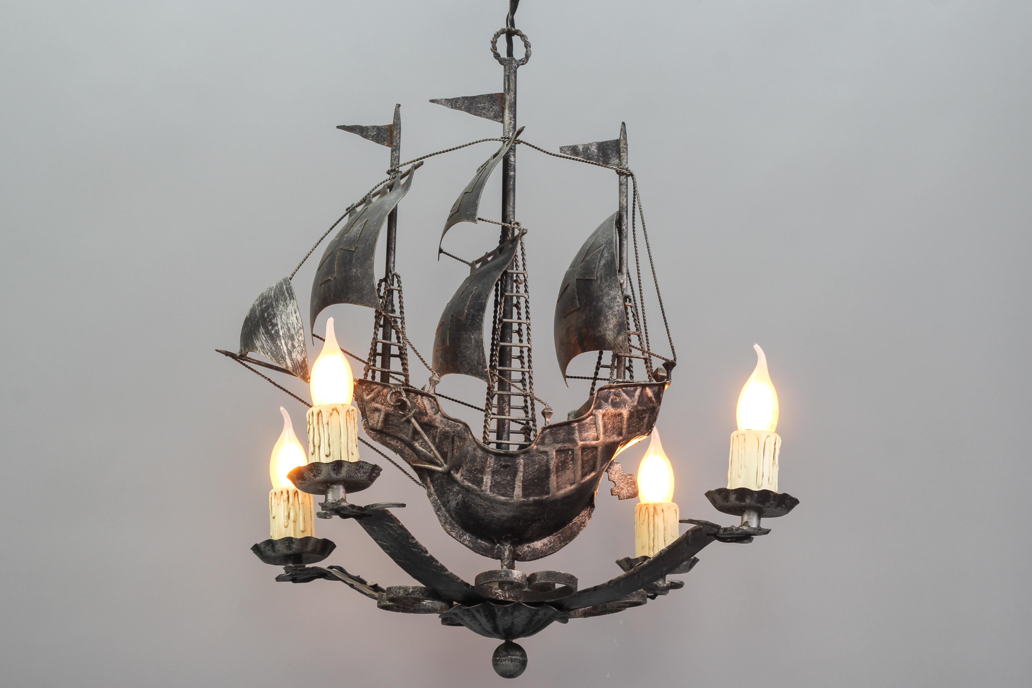 Wrought iron Spanish Galleon sailing ship-shaped four-light chandelier, the 1950s
The impressive silver-colored iron four-light chandelier represents a beautiful Spanish galleon with three masts and sailing ship details such as sails, ropes,