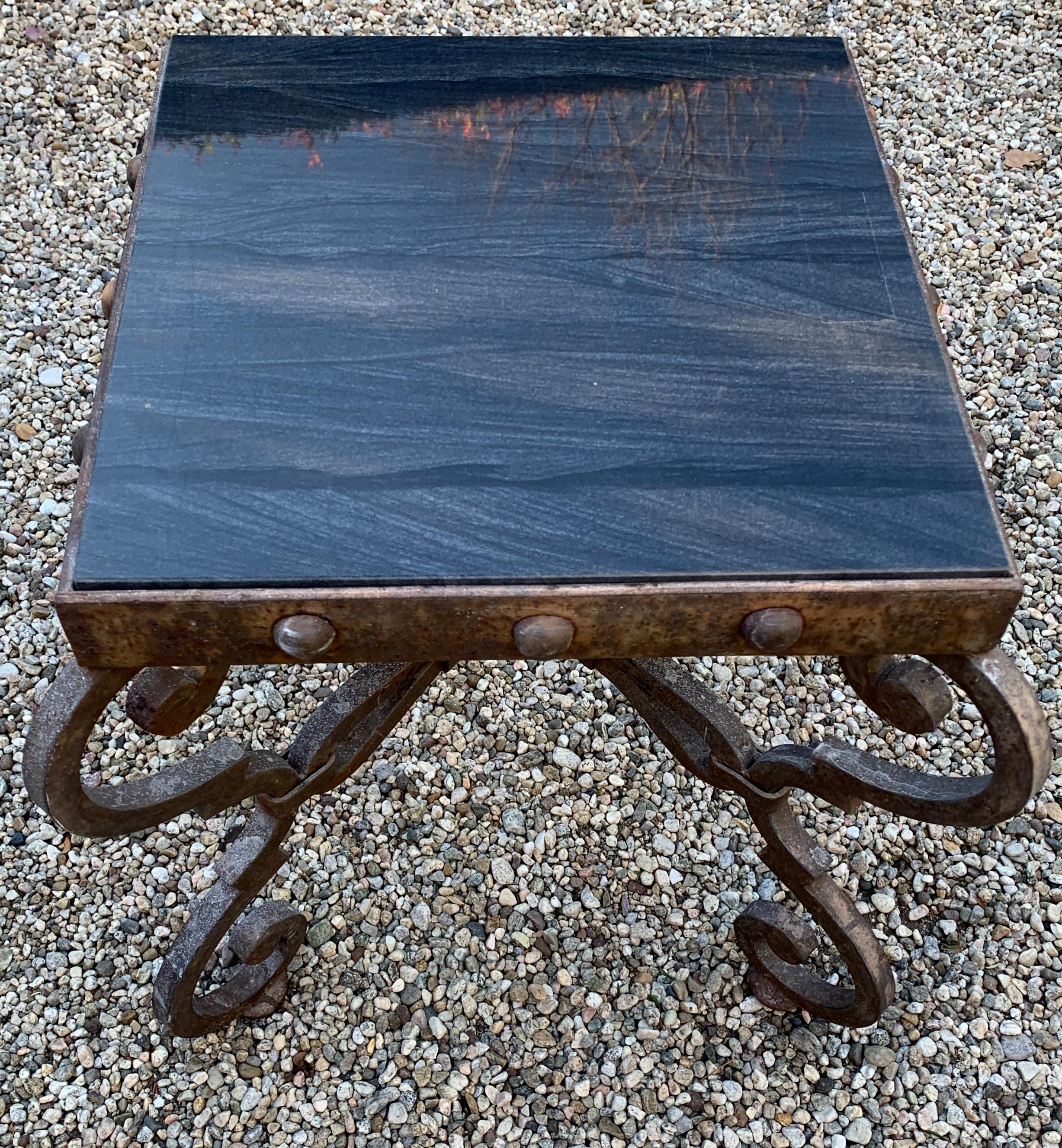 Wrought iron Spanish side table with decorative studs and detailing and patinated to perfection. We have added a new granite top. The side table is a compliment to indoor or outdoor settings. The stone top makes for a very durable surface. The