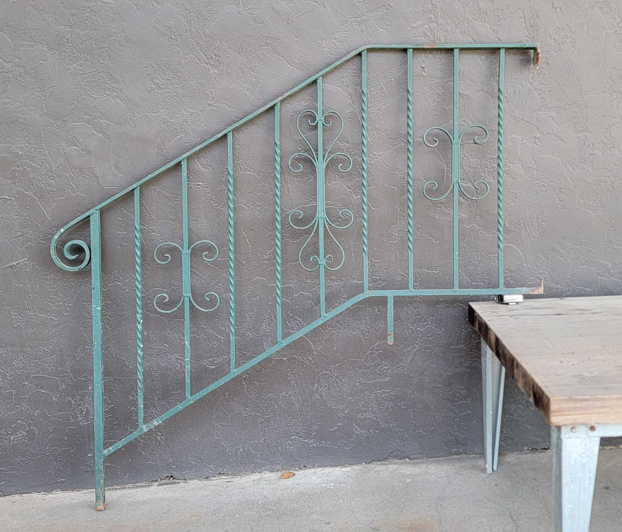 A hand wrought iron stair rail. Estimate to date from early 20th century. Old green paint with nice patina. Please see images for detailed measurements.

28.63 inches high.
54 inches wide.
1 inch deep.