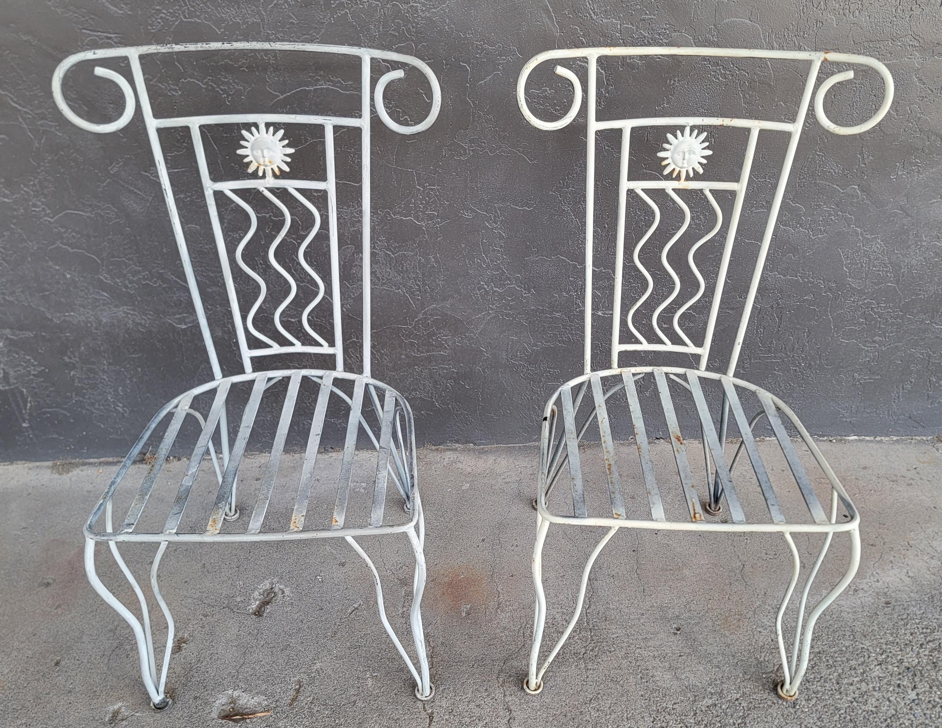 A pair of iron patio chairs. Substantial iron frames with a cast iron 