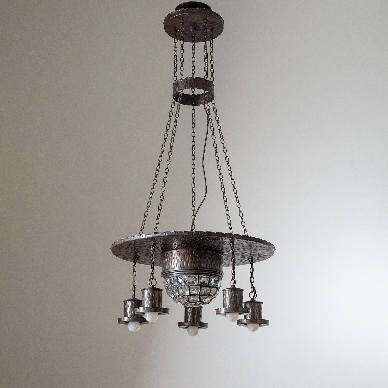 Rare Arts & Crafts wrought iron suspension chandelier from the early 20th century (1910-1920s). The entire structure is copper-plated with a lovely dark aged patina. Center piece is made of chunks of glass. Original copper and ceramic E27 sockets