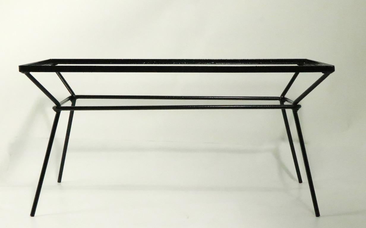 Architectural design wrought iron coffee table base after George Nelson for Arbuck, or Frank and Sons. The base has been newly powder-coated to a chic semi-gloss black finish, it accepts a drop in top, which could be glass, stone or wood (top edge
