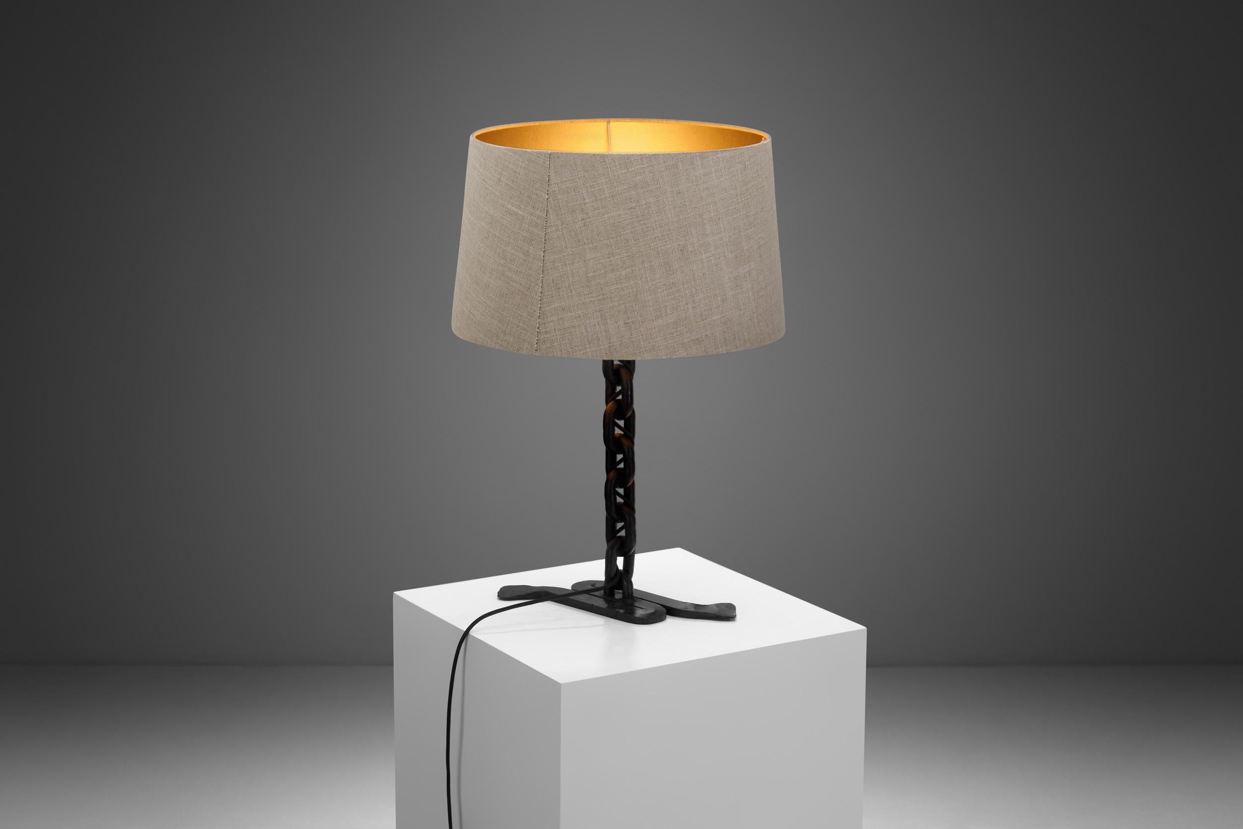 This individualistic table lamp is a Brutalist piece from the 1960s with a characteristic design that is sure to stand out. The style is similar to that of Franz West with wrought iron chain links constituting the body.

From architectural