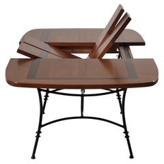 Wrought-iron table with solid cherry top - integrated extensions