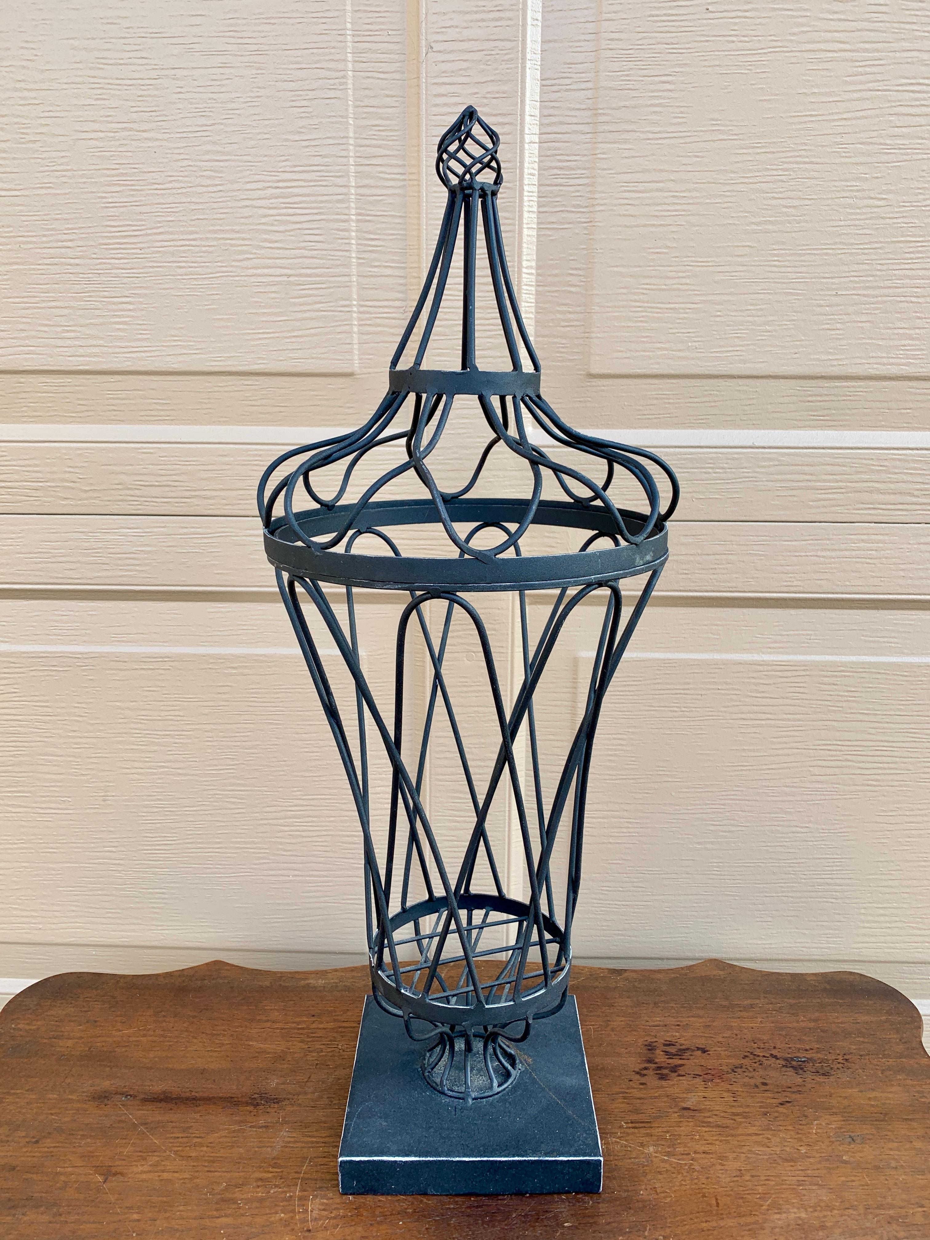 A gorgeous French Provincial black wrought iron planter with topiary form. This piece could also be used as a candle holder. 

USA, Late-20th Century

Measures: 9