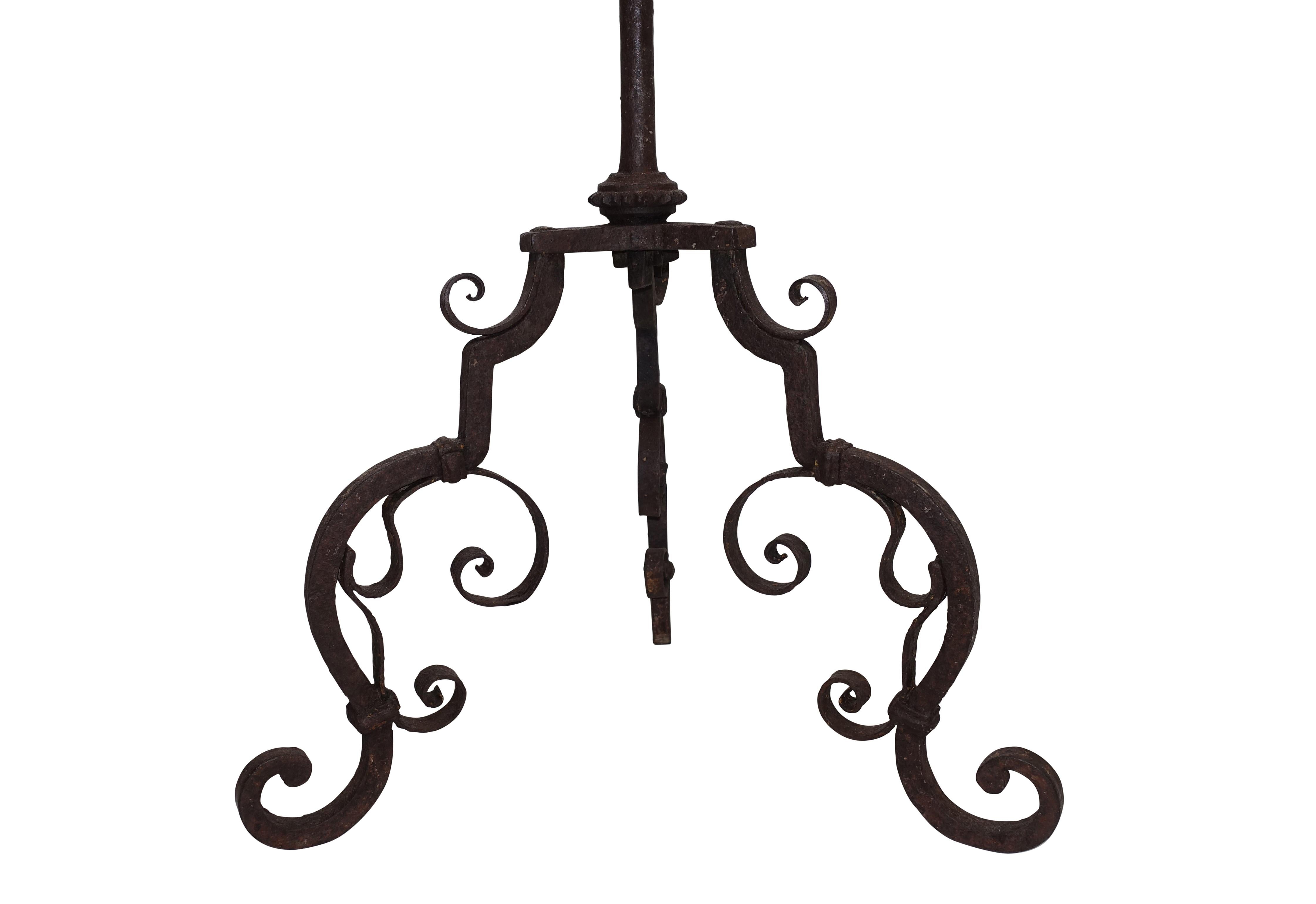 A hand-wrought iron candle stand with brass center detail, European 18th century.