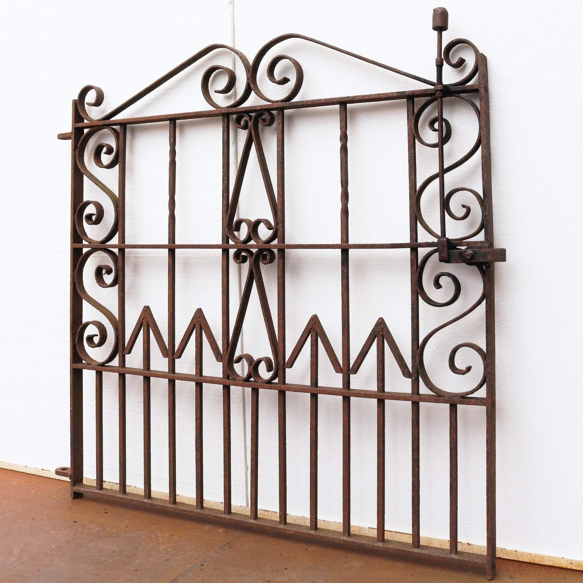 This Victorian garden gate has stood the test of time for more than 120 years. Made at the hand of a skilled 20th century blacksmith, it is ornately detailed with a range of scrollwork and arrow-shaped details that are a beautiful addition to an