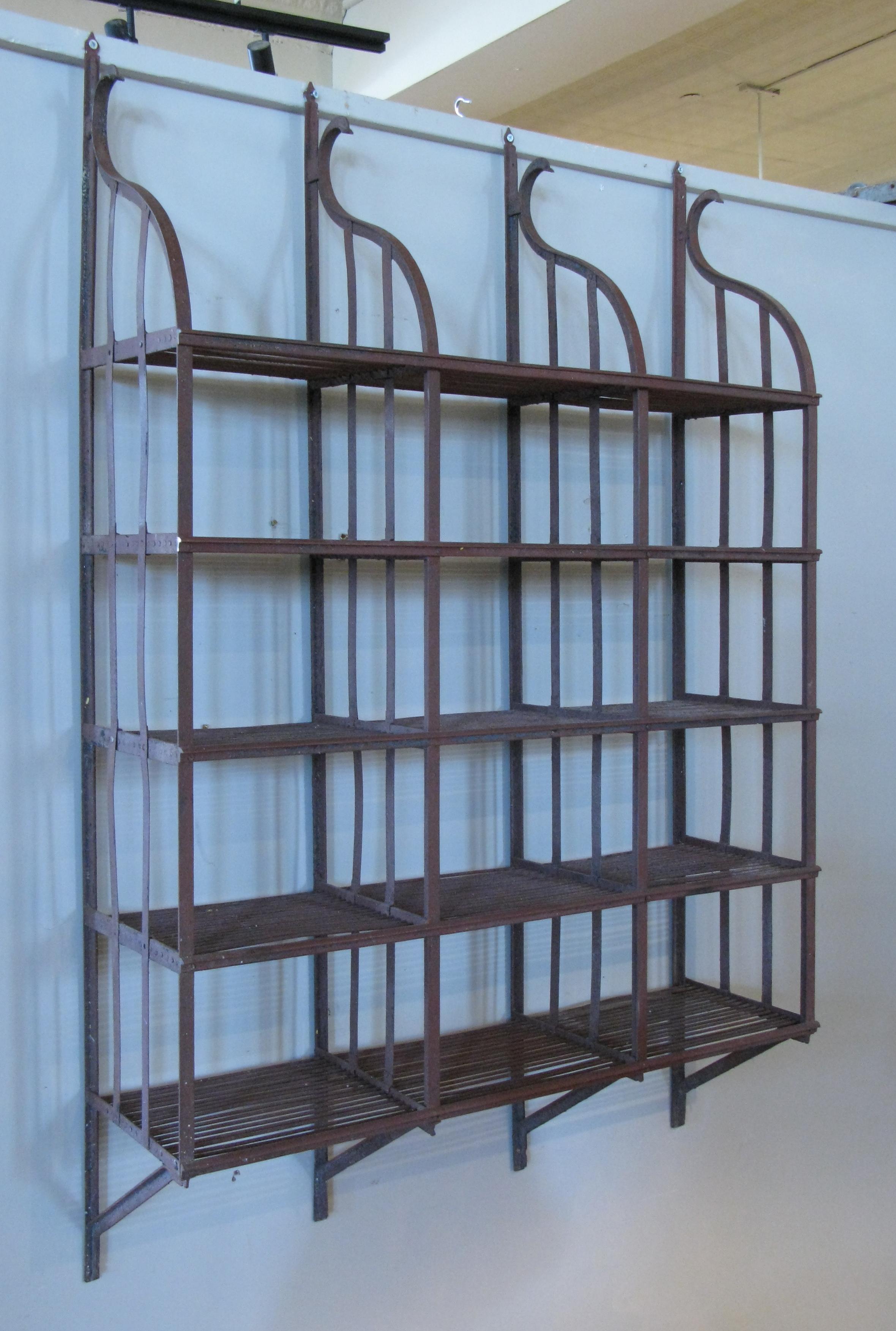 A beautiful vintage 1950s wrought iron wall-mounted hanging shelving rack, with curved top and five shelves. Perfect for kitchen, books, or plants.